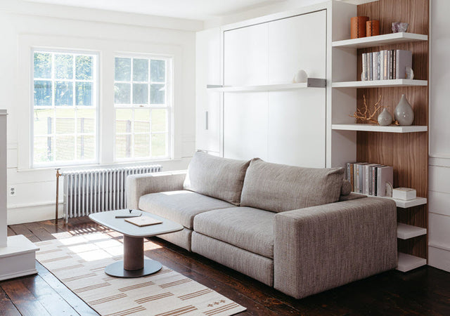 Image of the Tango Sectional Wall Bed in its closed position, accompanied by the Dynamic Table in front of the sofa.