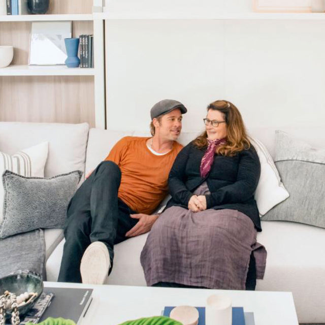 Brad Pitt and Jean Ann Black relaxing on the Swing sofa-wall bed, capturing the warmth and intimacy of their friendship in a beautifully designed multifunctional space.