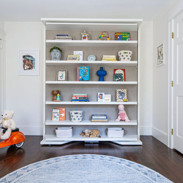 LGM Murphy wall bed (Resource Furniture) folded as white shelving in a kids' room — space-saving, multifunctional furniture for small bedrooms.