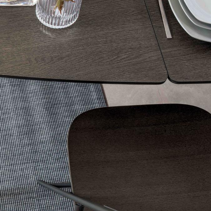 Close-up view of the Surf table's smooth wood veneer surface and beveled edges, highlighting its luxurious finish and craftsmanship.