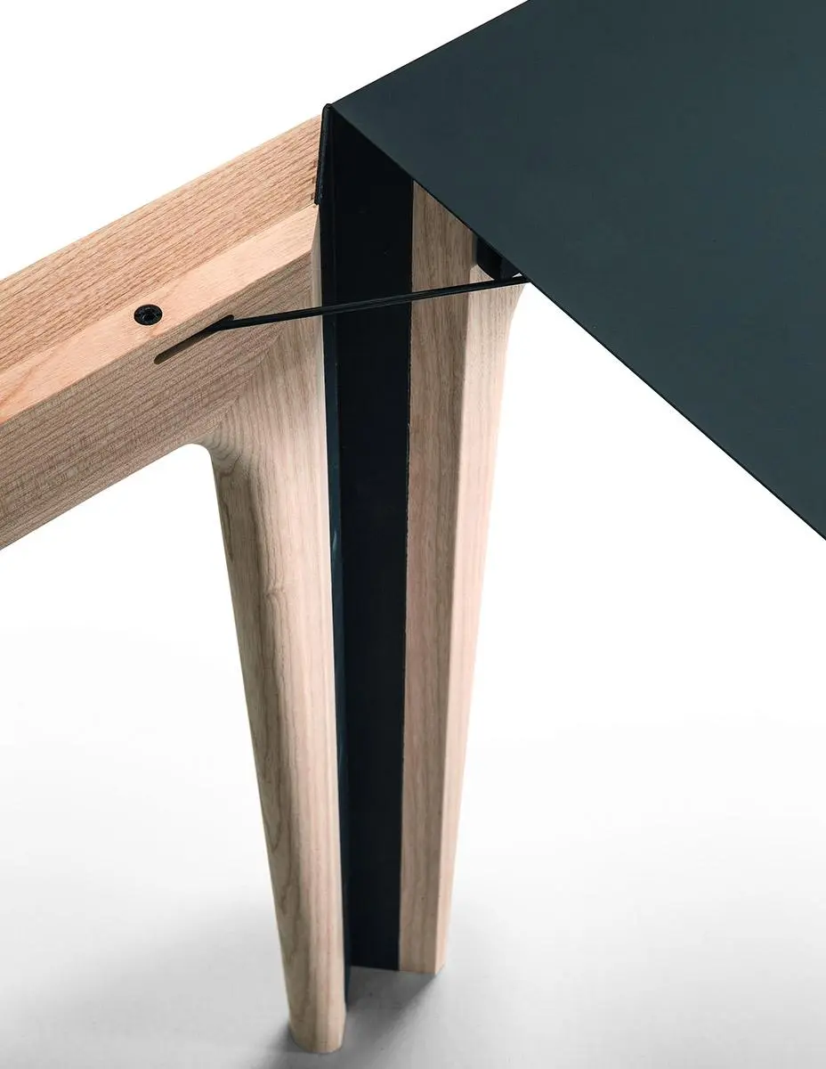 Close-up of Amalong extension dining table’s patented rotating mechanism with black tabletop and ash wood leg.