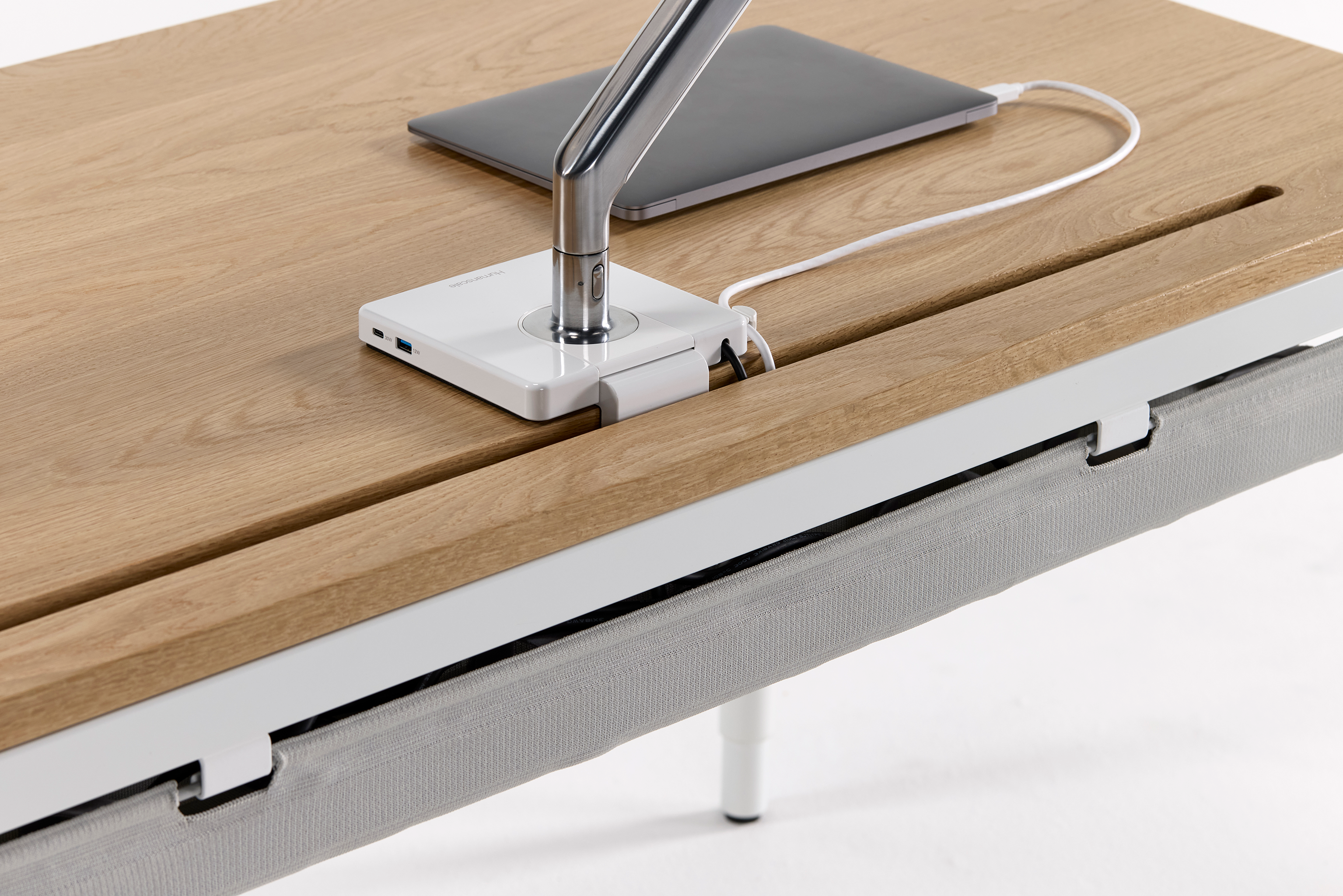 Close-up of eFloat Quattro desk edge showing seamless surface integration and cable management.