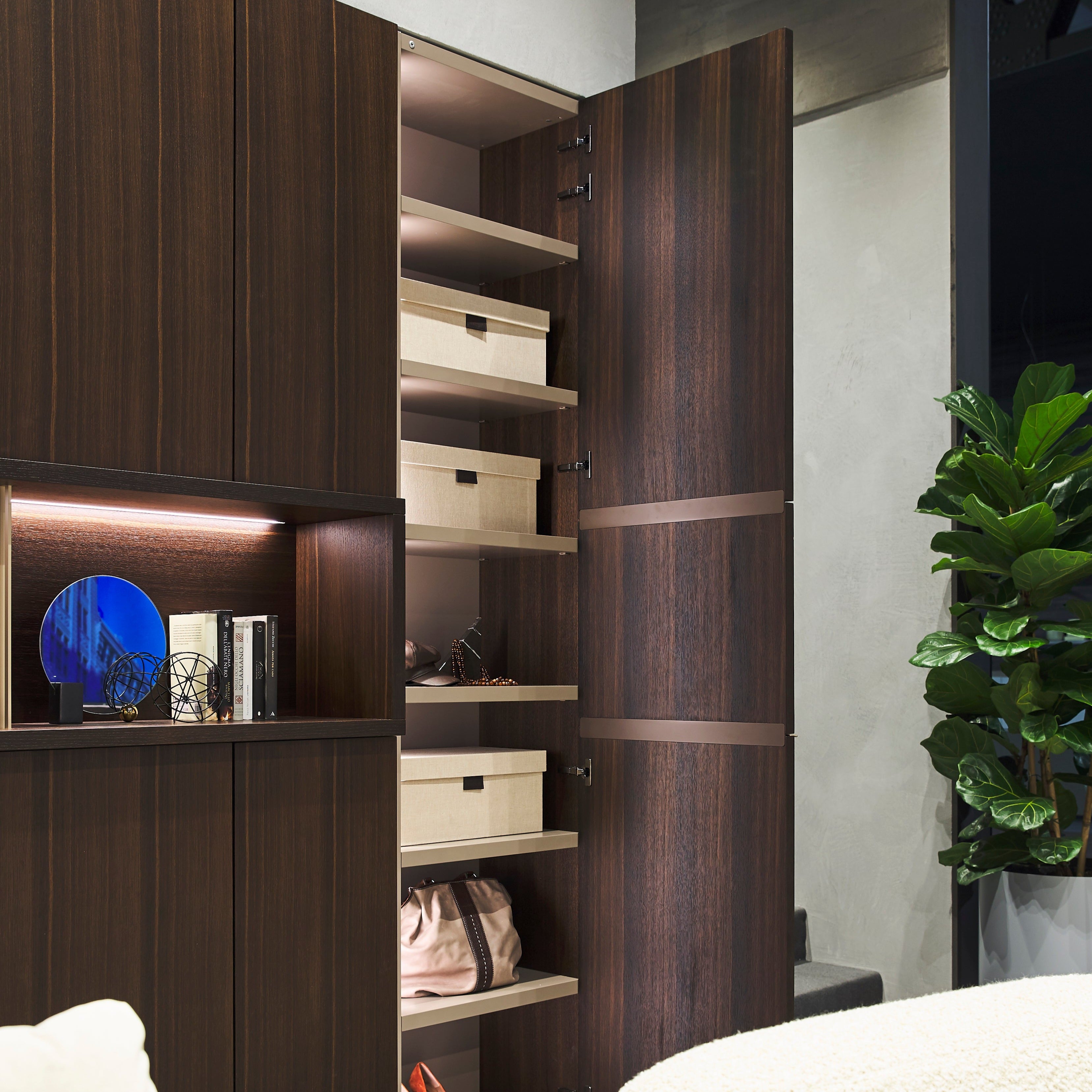 Open custom entryway cabinet with shelving, storage boxes, and integrated lighting – space saving furniture by Resource Furniture.