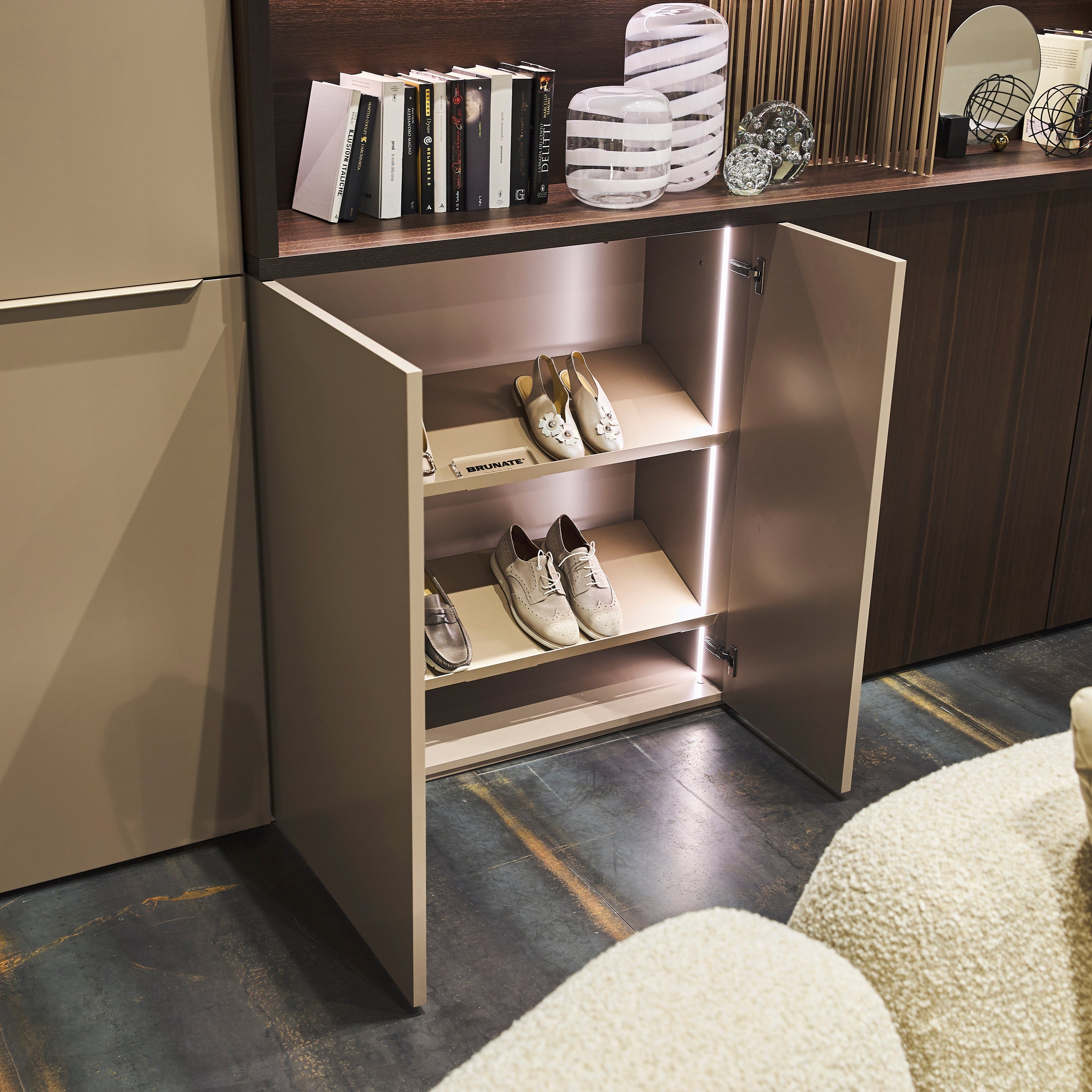 Detail view of custom entryway cabinet with integrated shoe storage shelves – space saving furniture by Resource Furniture.