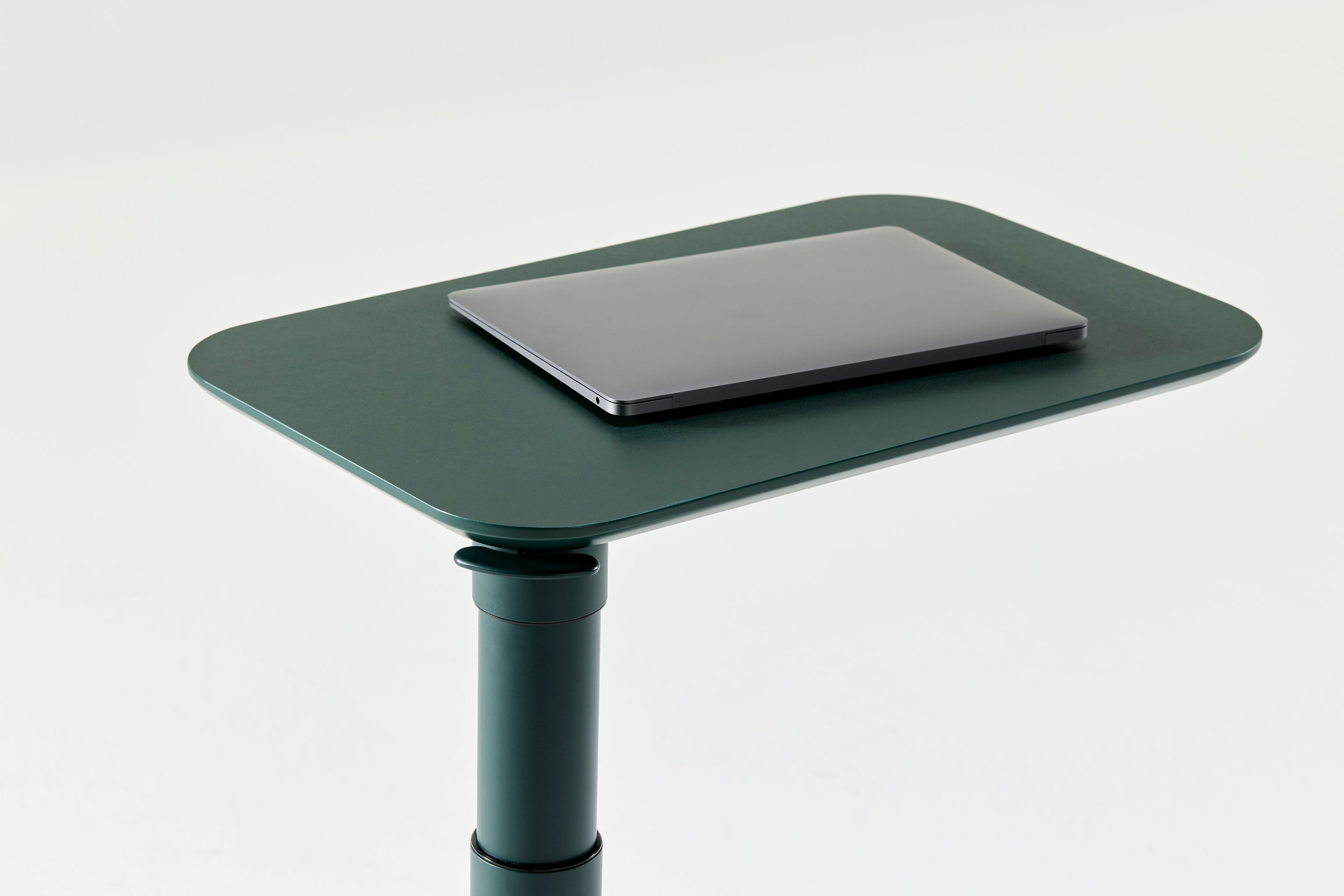 Detail of Float Micro’s black tabletop with integrated handle, emphasizing portable design.