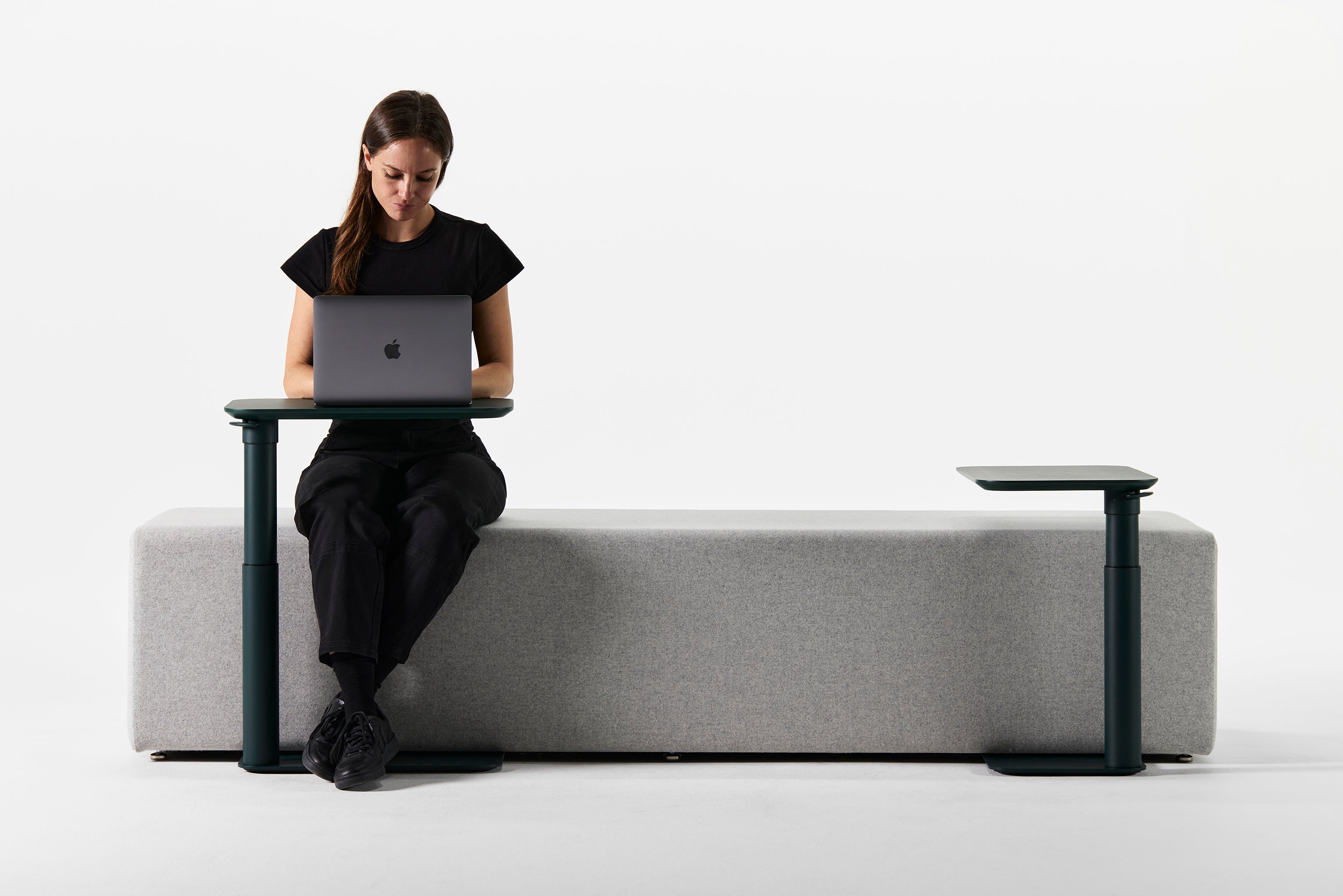 Side profile view of a user demonstrating the adjustable height function of Float Micro.