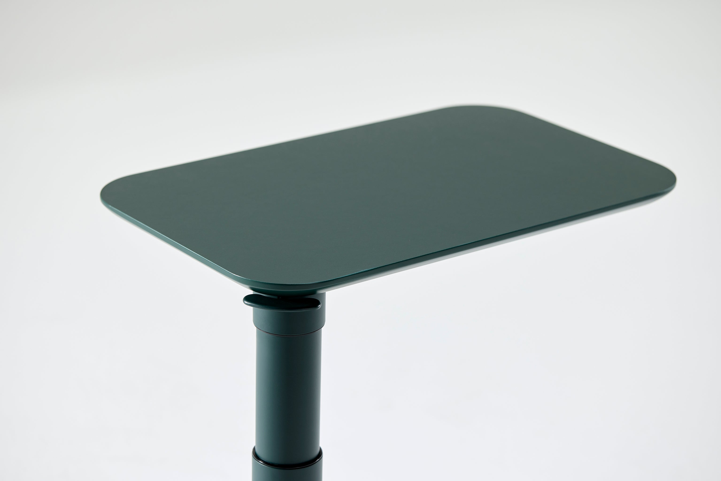 Angled side view of the Float Micro tabletop in black, showcasing its slim, minimalist profile.