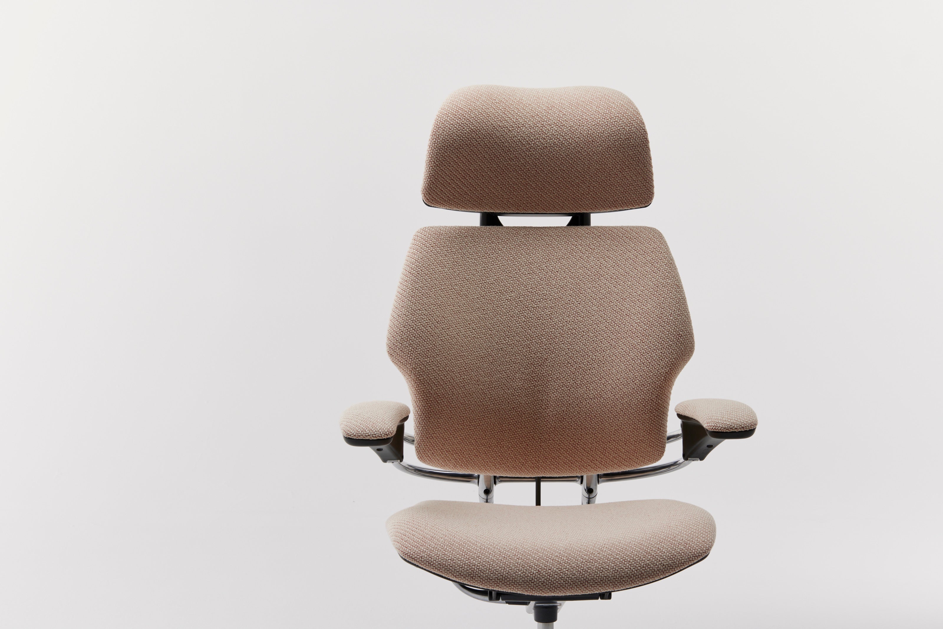 Front-facing view of the Freedom Headrest ergonomic office chair in beige Kvadrat upholstery, showcasing its contoured design.