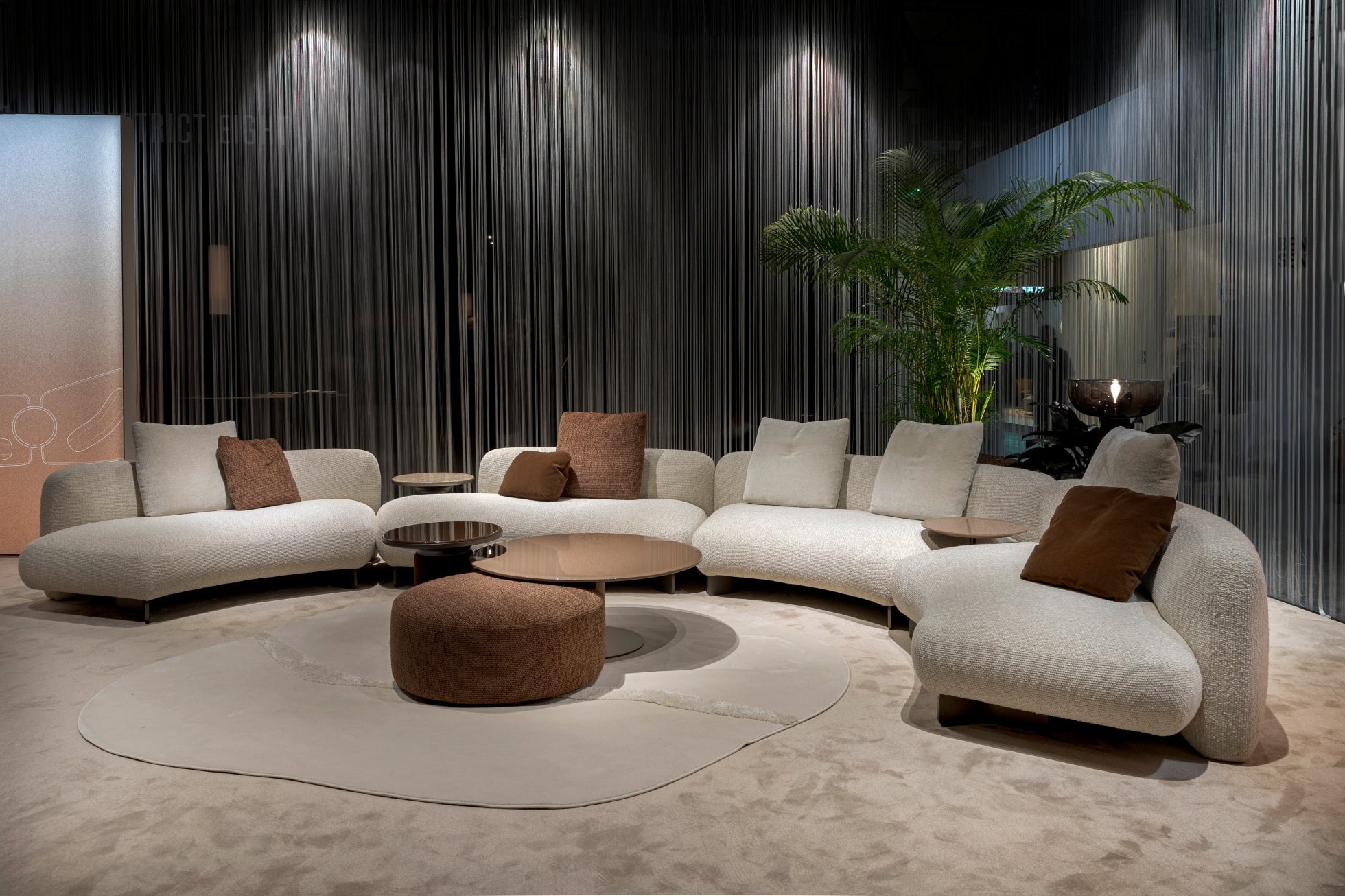 Kintai modular curved sectional sofa in cream and brown upholstery by Resource Furniture, featuring deep seating and sculptural lines.