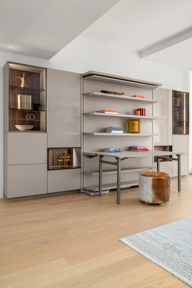 LGM Murphy bed in table configuration with shelving and ottoman, featured in a multifunctional NYC studio at One Wall Street.
