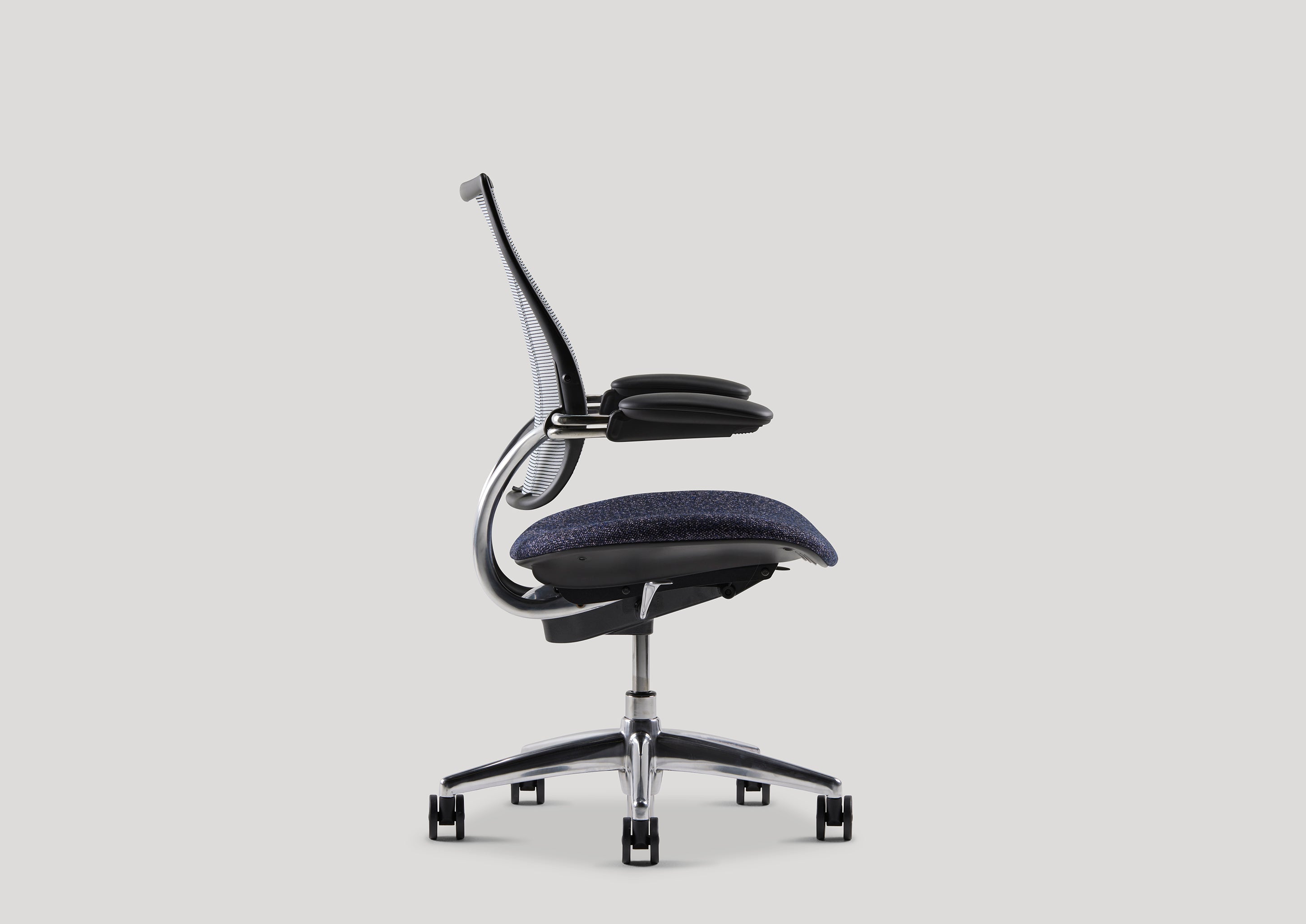 Side profile of Liberty Task Chair highlighting automatic recline mechanism and navy seat upholstery