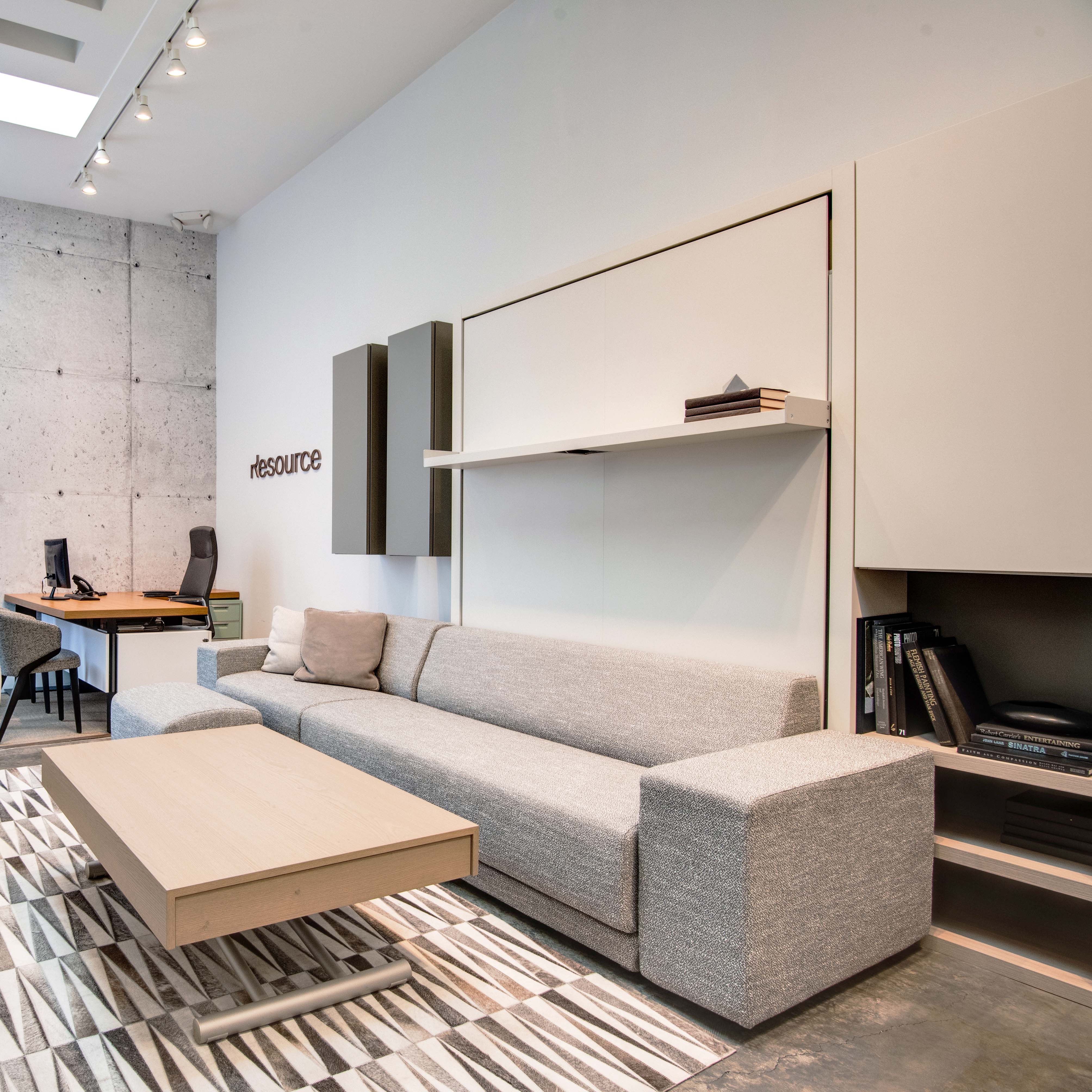 Oslo sectional Murphy bed in closed position with gray sofa on display in Resource Furniture’s Los Angeles showroom.