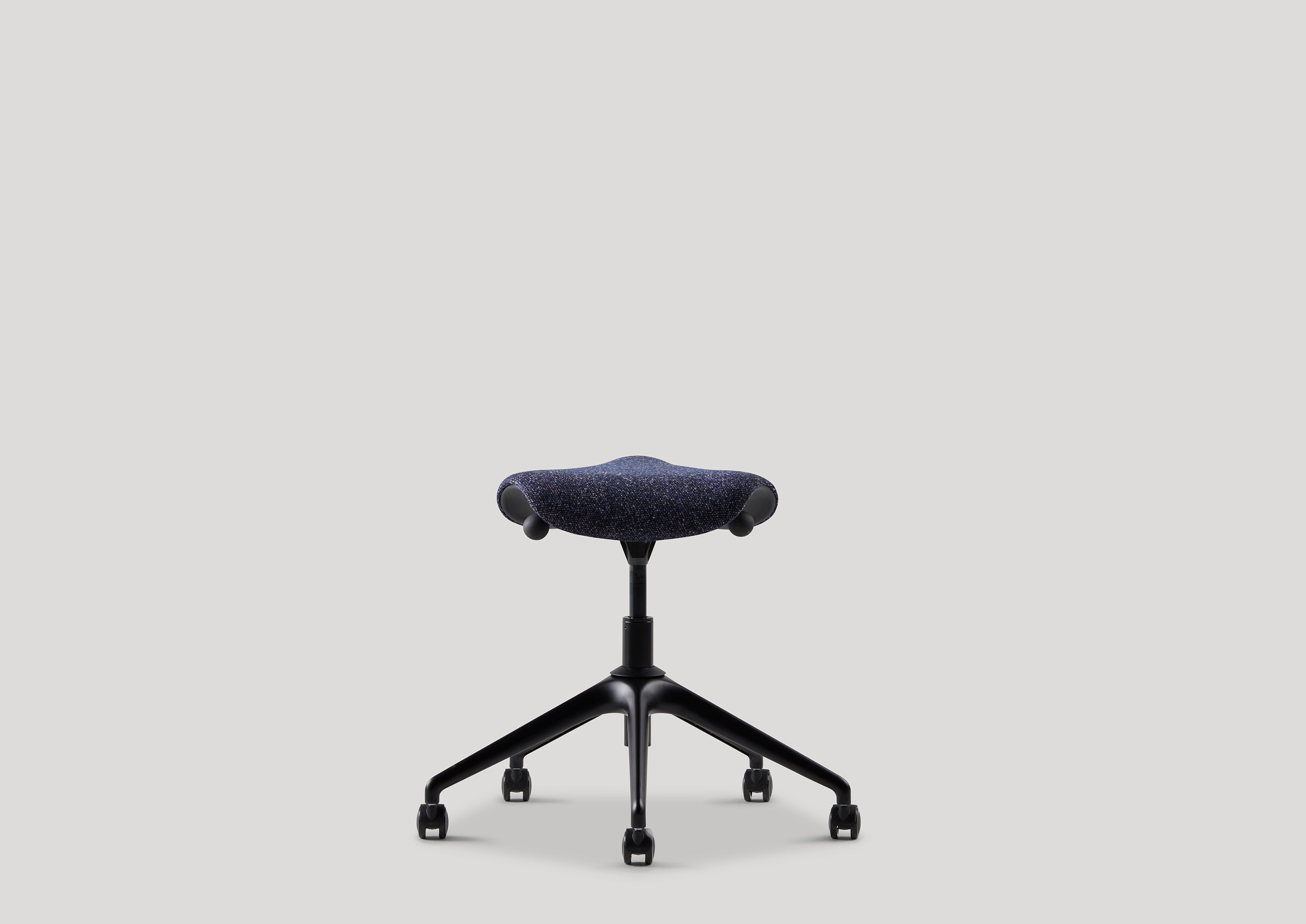 Ergonomic Humanscale Pony saddle seat task stool in blue upholstery, front view.