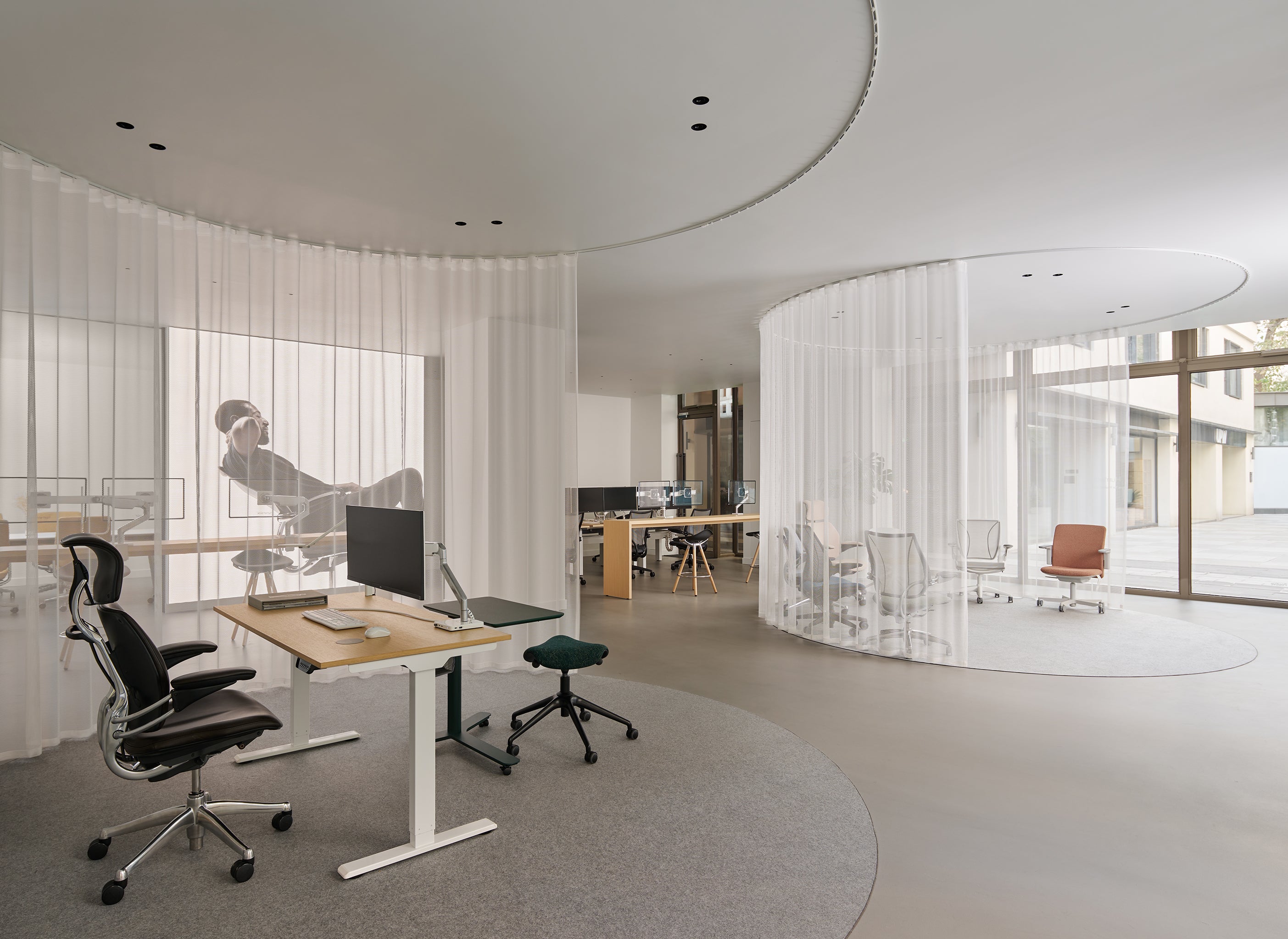 Open-concept modern office showcasing multiple Humanscale seating solutions including the Pony saddle stool.