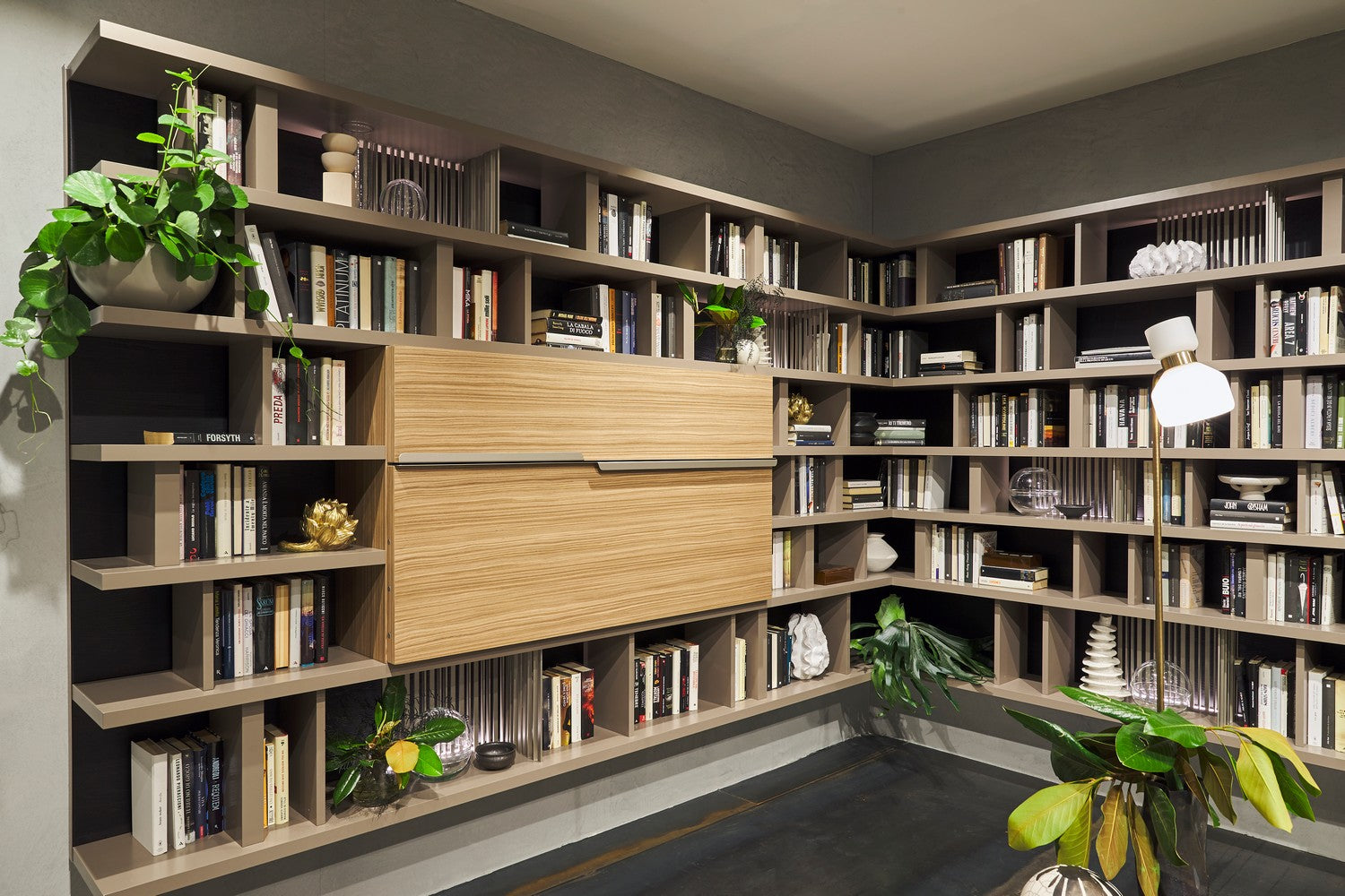Maxi Bar closed with wood front panels, integrated into a custom library wall system with bookshelves and display storage.