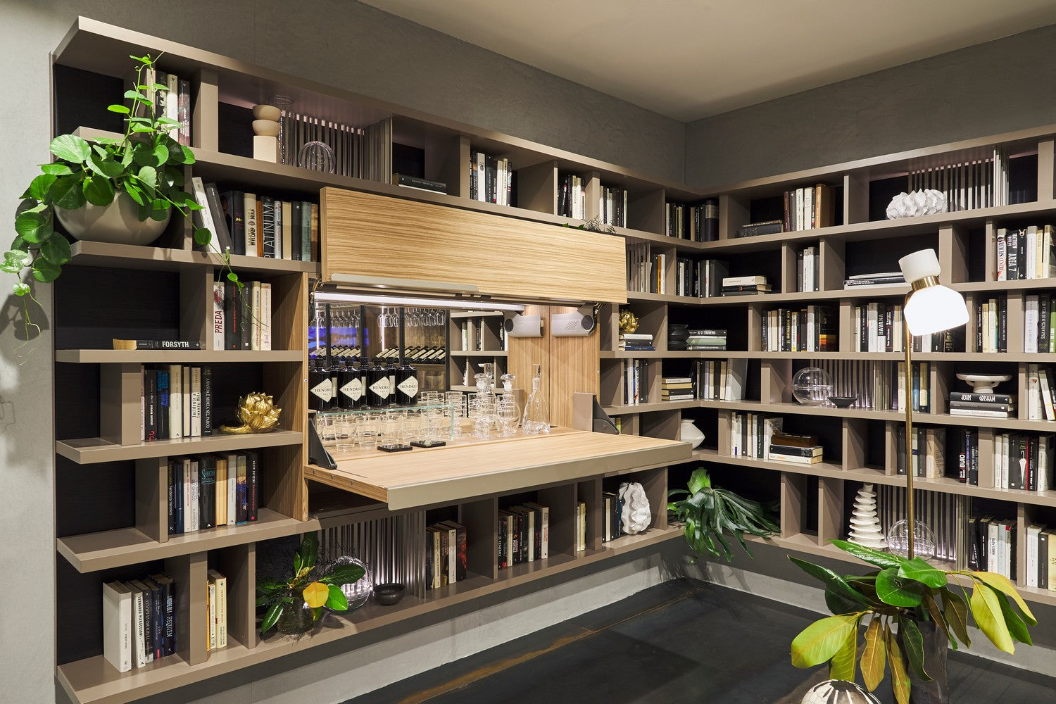 Maxi Bar open as a concealed home bar integrated into a custom library wall system with shelving and barware.