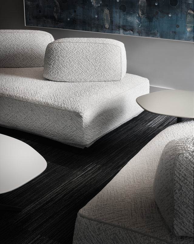 Flex sofa (white boucle) at Resource Furniture Seattle showroom — textured sofa with white tables on black rug. Photo: Anton Benedikt