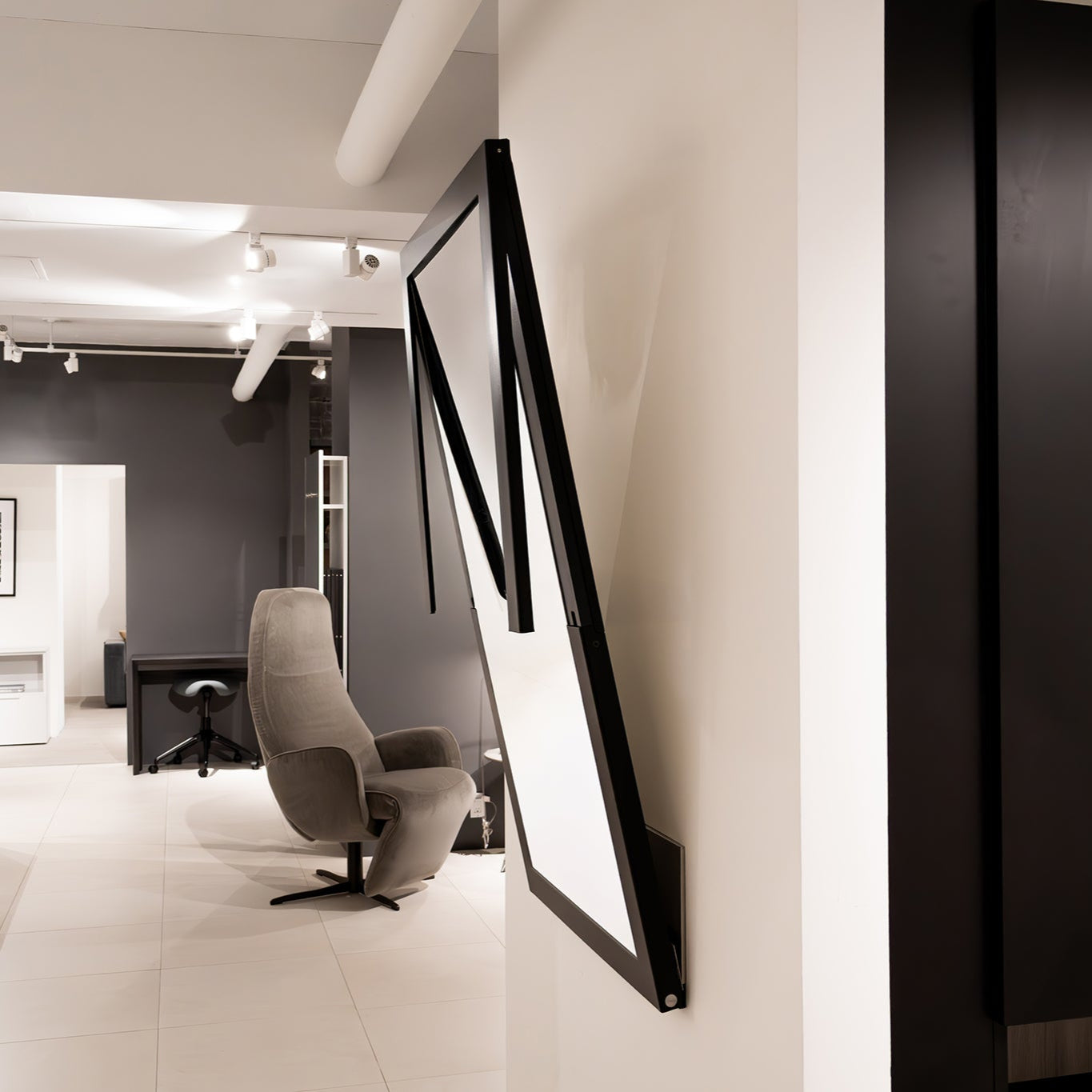 Folding Specchio mirror midway through converting into a functional wall-mounted table.