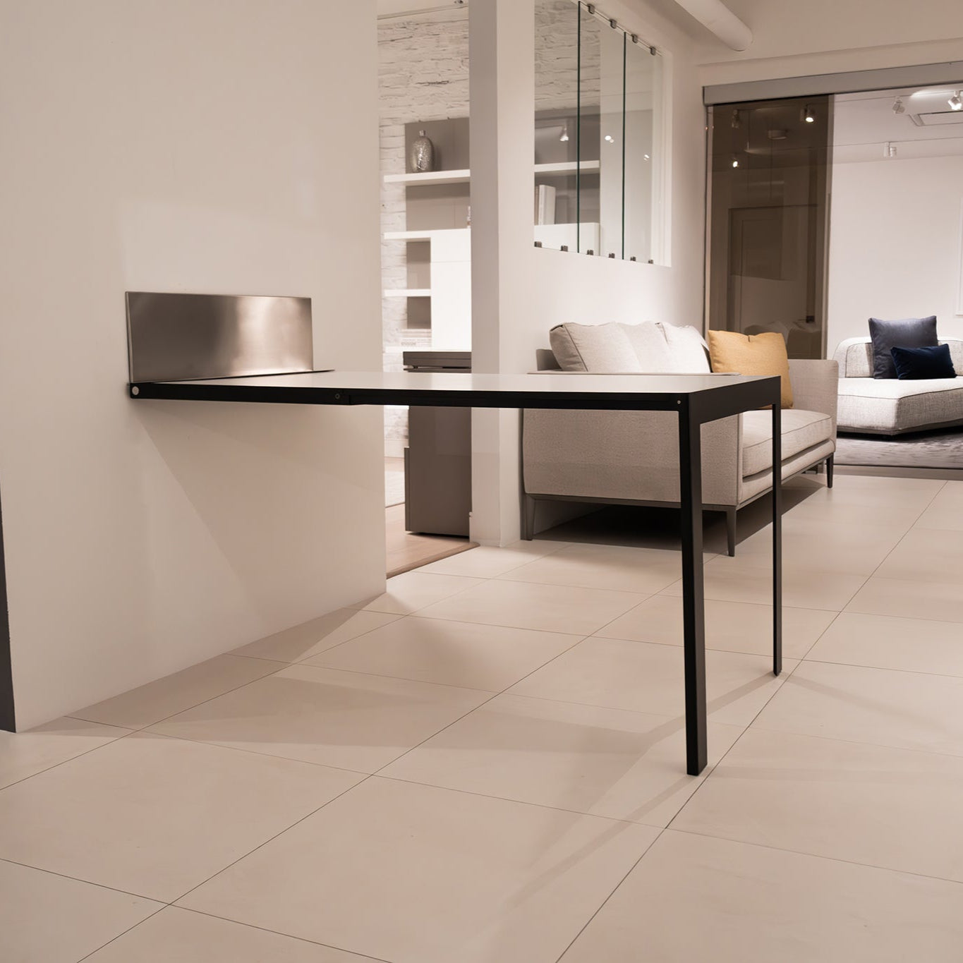 Specchio mirror fully transformed into a modern dining or work table in a compact living space.