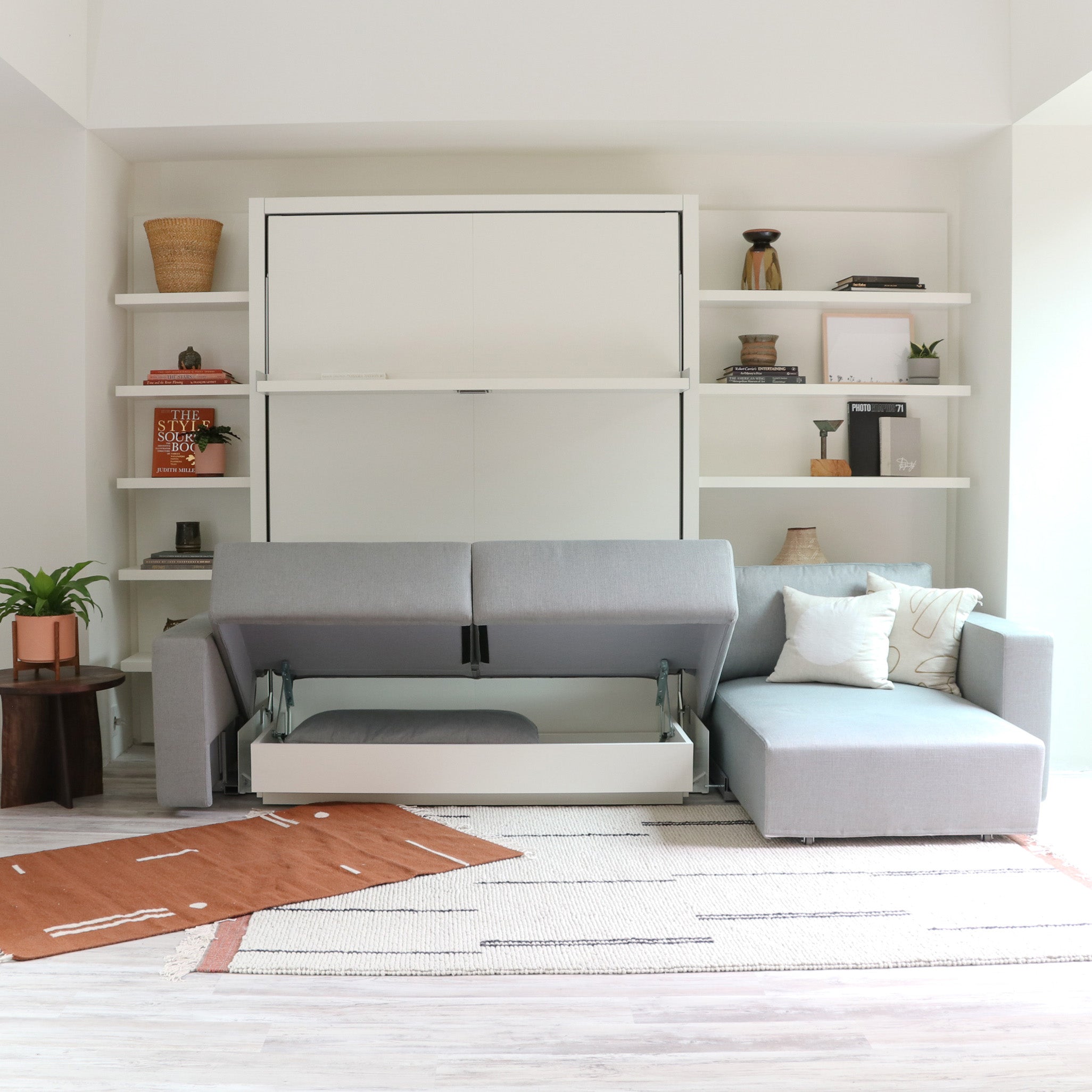 Hidden under-seat storage shown open in the Swing Chaise sectional in front of the Swing wall bed.