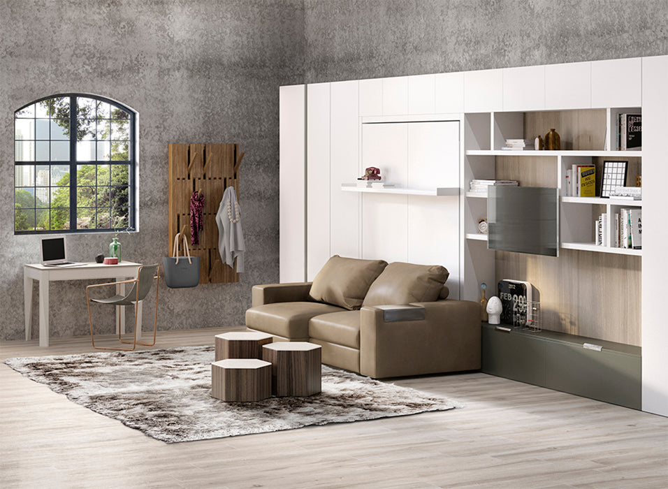 Modern living room with white wall-mounted Murphy bed, brown two-seat Tango Sofa, built-in shelving, and compact home office setup.
