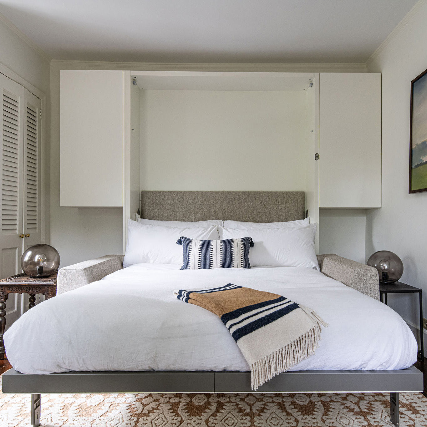 Fully extended Tonale Murphy bed with sofa, shown in bed position with plush bedding, ideal modern furniture for small spaces.