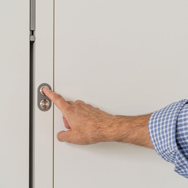 Close-up of the opening button on the Tonale Sofa Murphy bed, demonstrating simple and intuitive motorized operation of this space saving furniture solution.
