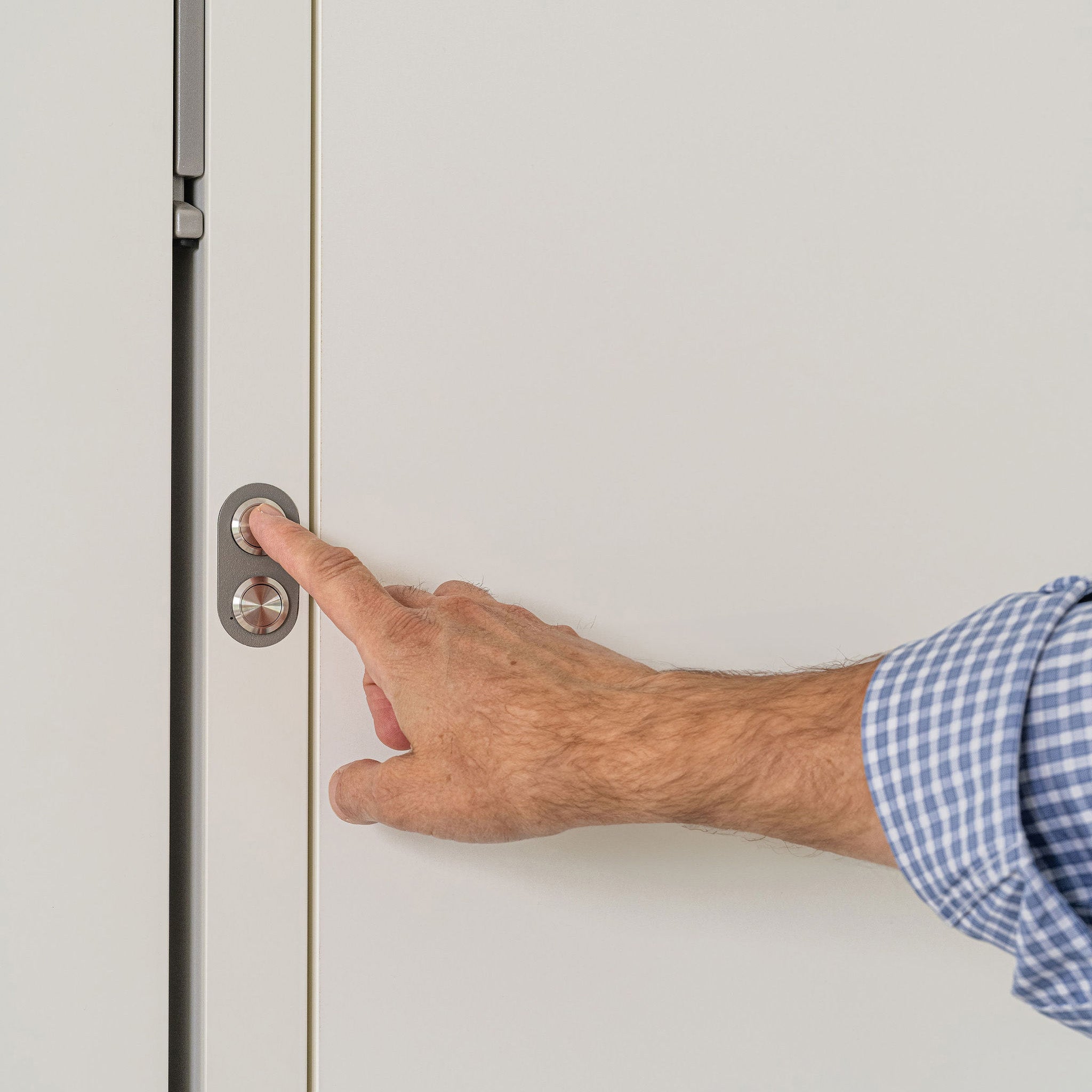 Close-up of the opening button on the Tonale Sofa Murphy bed, demonstrating simple and intuitive motorized operation of this space saving furniture solution.