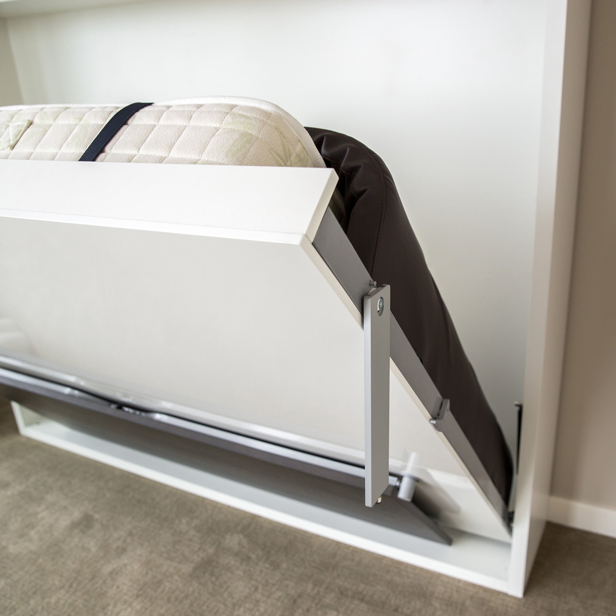 Close-up view of the Adam Tavolo Queen Murphy bed in transition from desk to bed position, highlighting the smooth folding mechanism and multifunctional design.