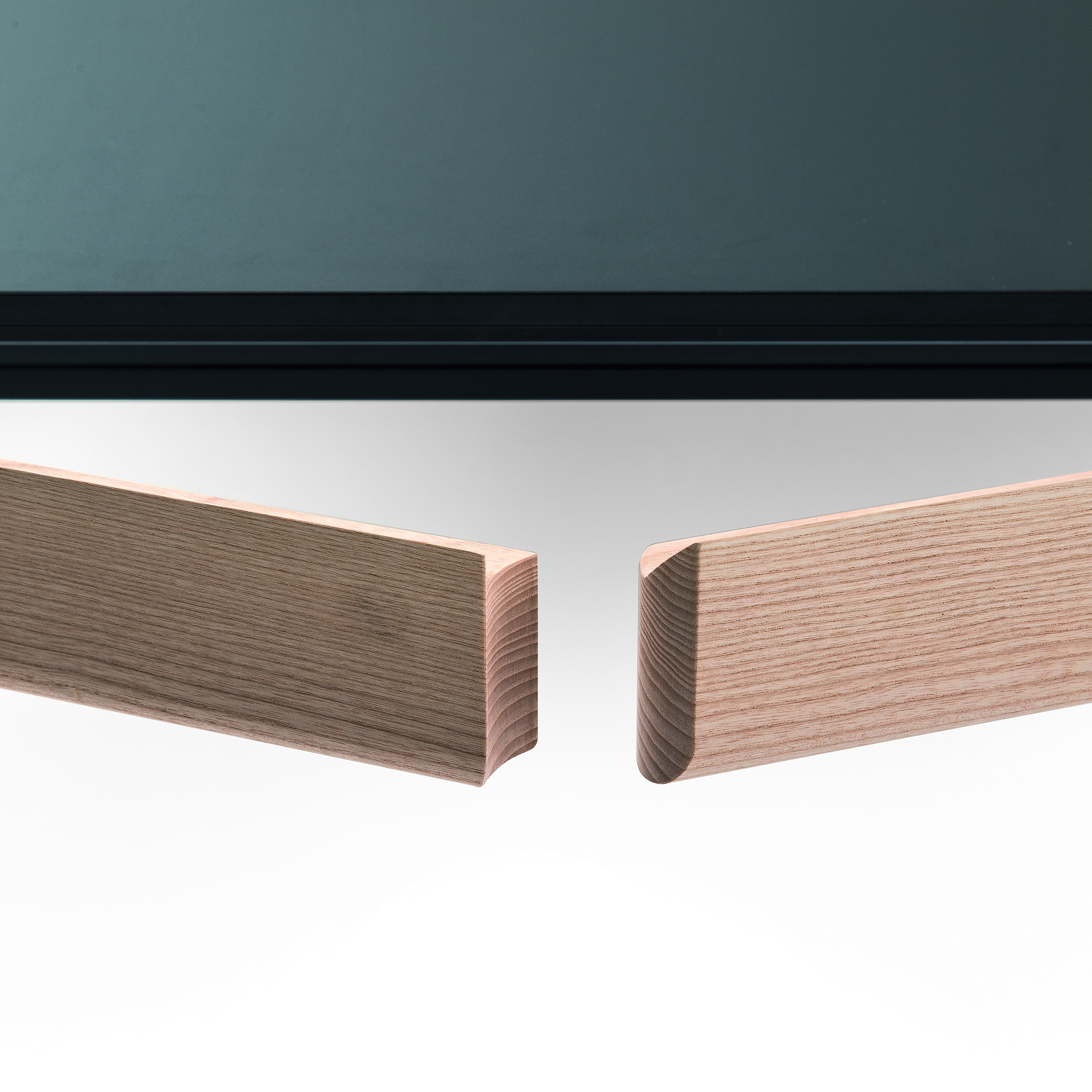 Close-up of Amalong table’s concealed extension mechanism showing separated ash wood frame beneath black tabletop.
