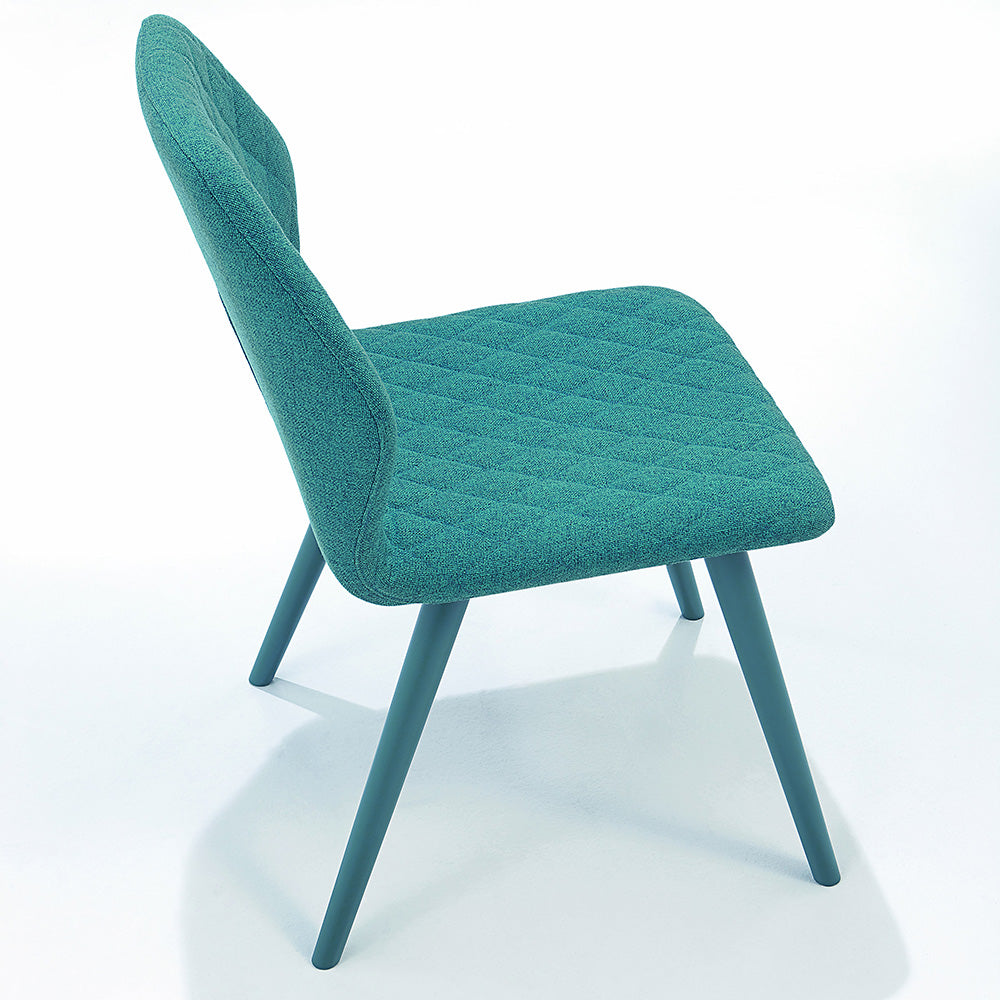 Side view of Ava dining chair in teal diamond-quilted upholstery with tapered blue legs, shown against white background.