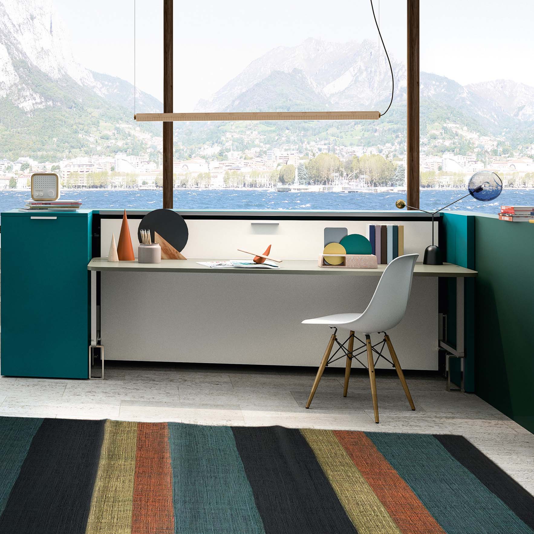 Cabrio Murphy Bed with integrated desk in a vibrant teal setup, shown in a compact home office with mountain and lake view – multifunctional space saving furniture.