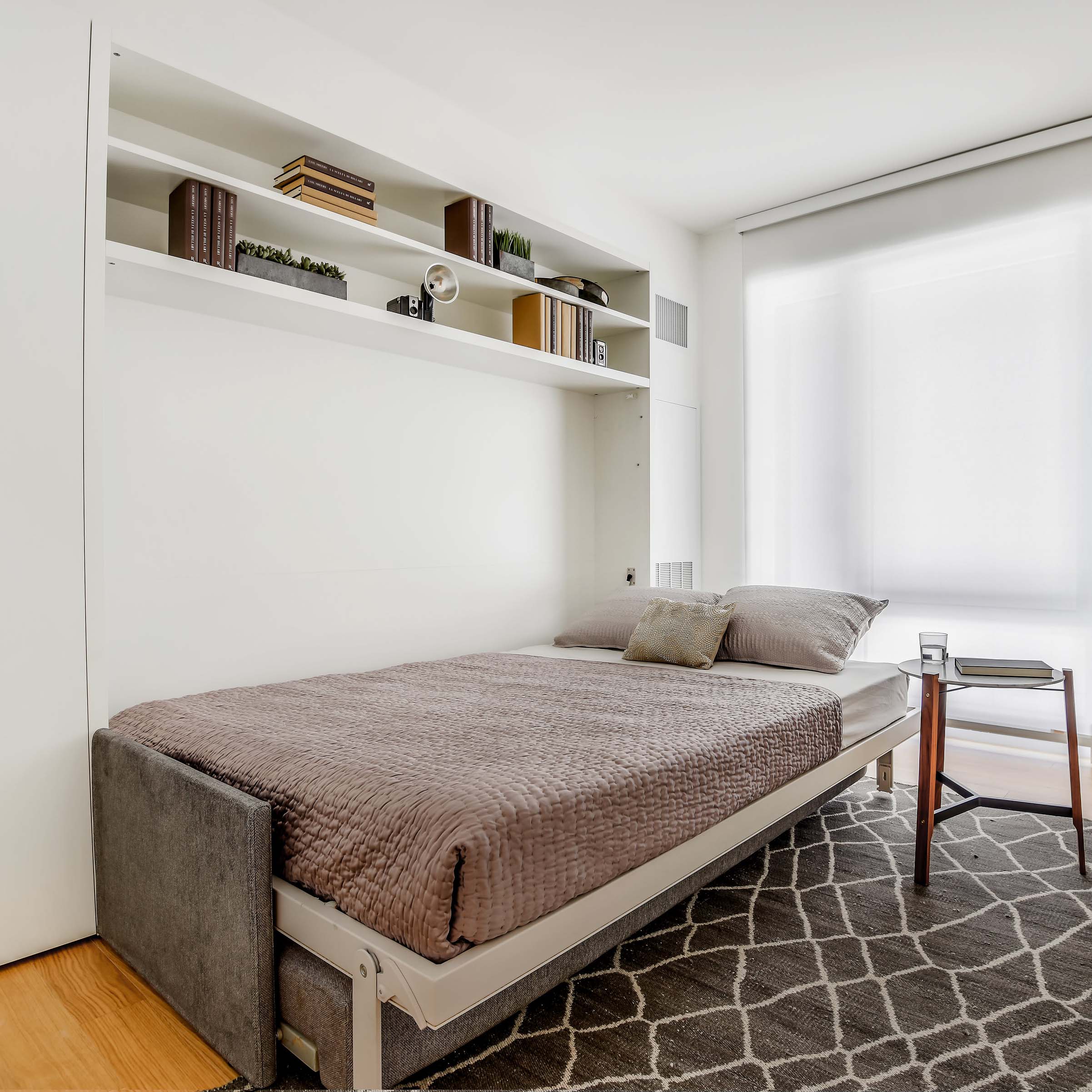 Circe Sofa wall bed open to reveal a horizontal queen Murphy bed with plush upholstery and built-in sofa base.