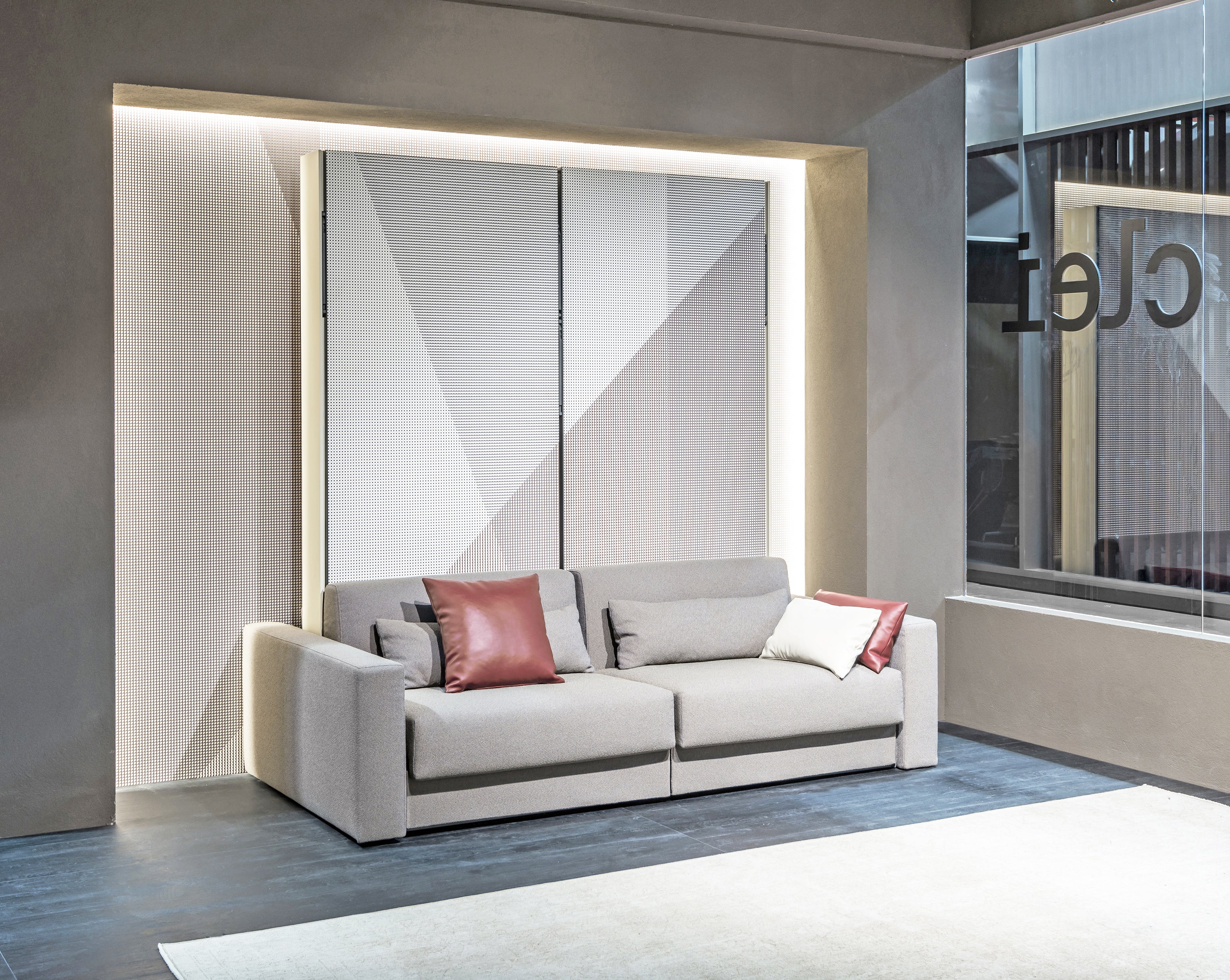 Circe Sofa shown in closed position with a horizontal queen wall bed concealed behind modern paneling and a gray upholstered sofa.