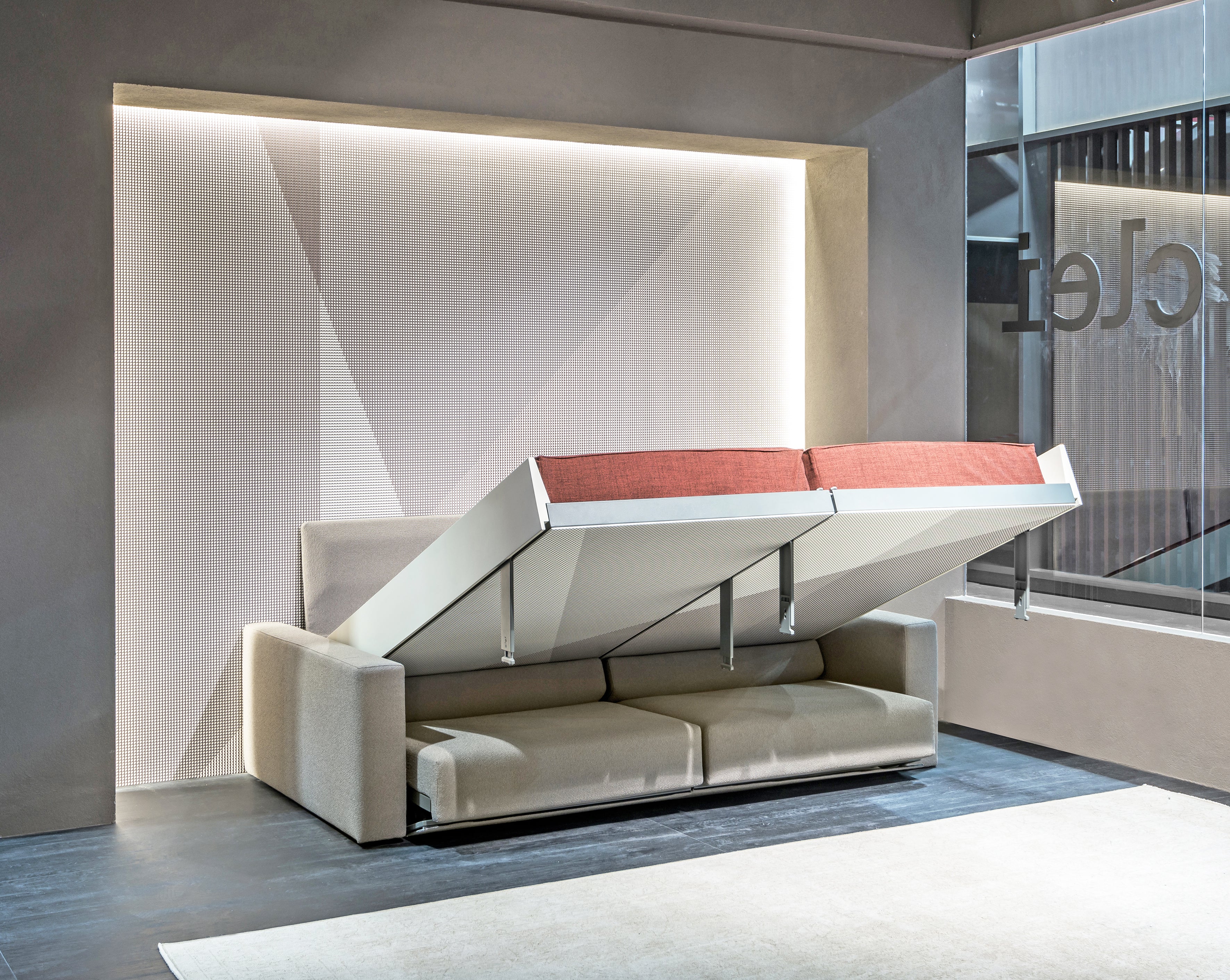 Ella & Louis freestanding queen wall bed with sofa partially unfolded, showing the transition from couch to bed with rust-colored mattress.