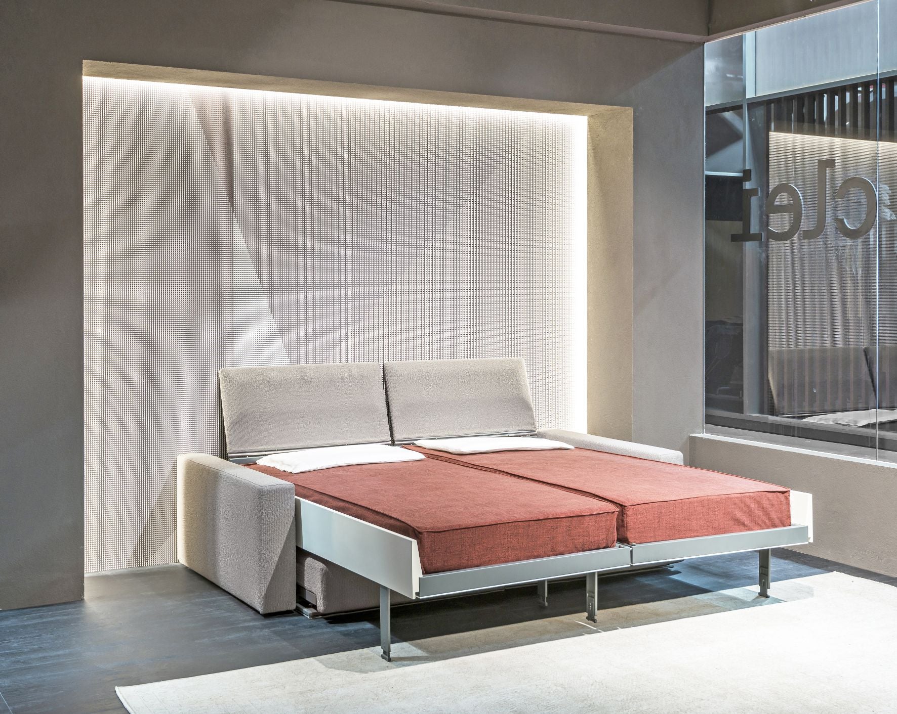 Ella & Louis freestanding queen wall bed with sofa, shown fully extended as a queen-sized bed with rust-colored bedding.