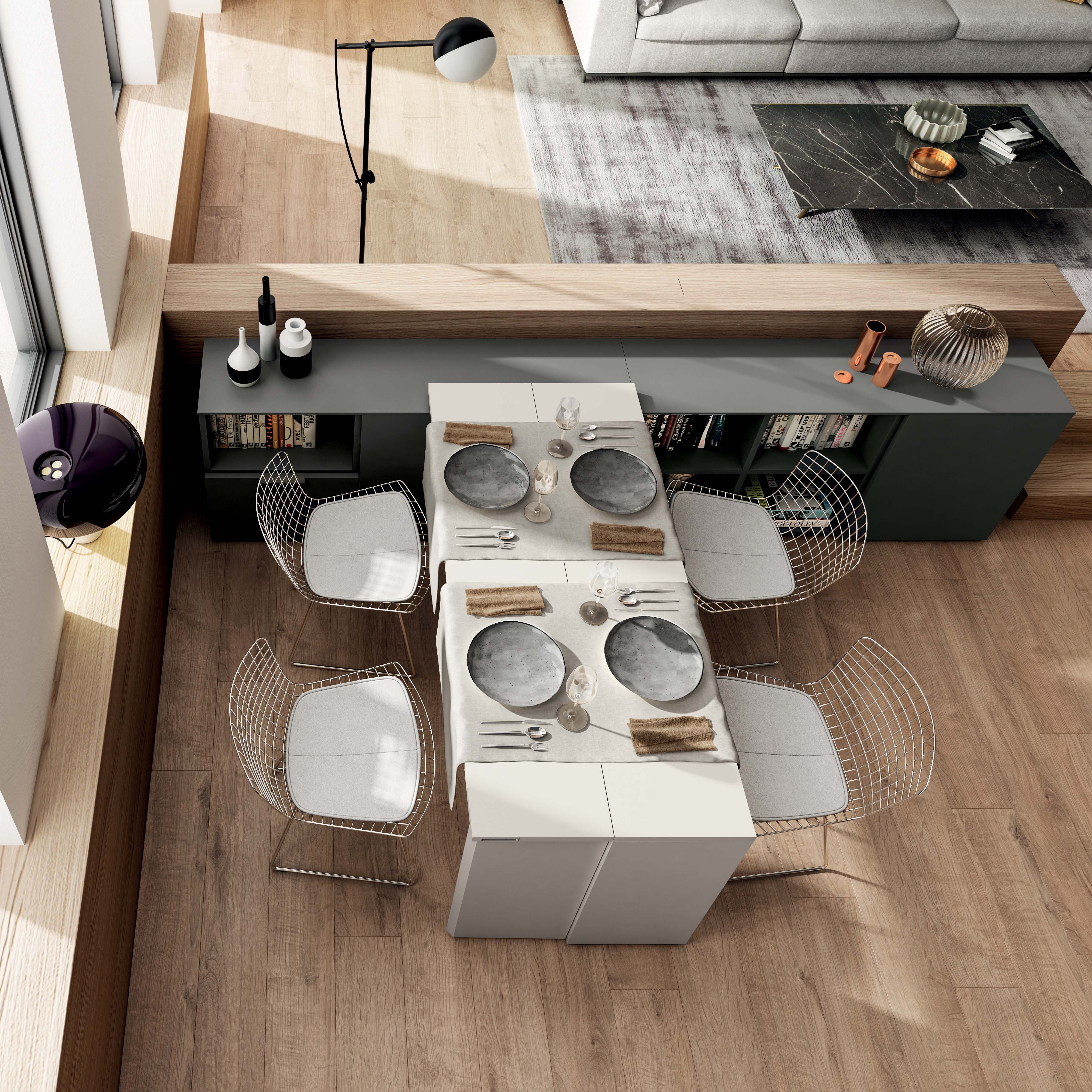 Overhead view of the Giro transforming console table extended into a dining setup with four chairs in a modern apartment by Resource Furniture
