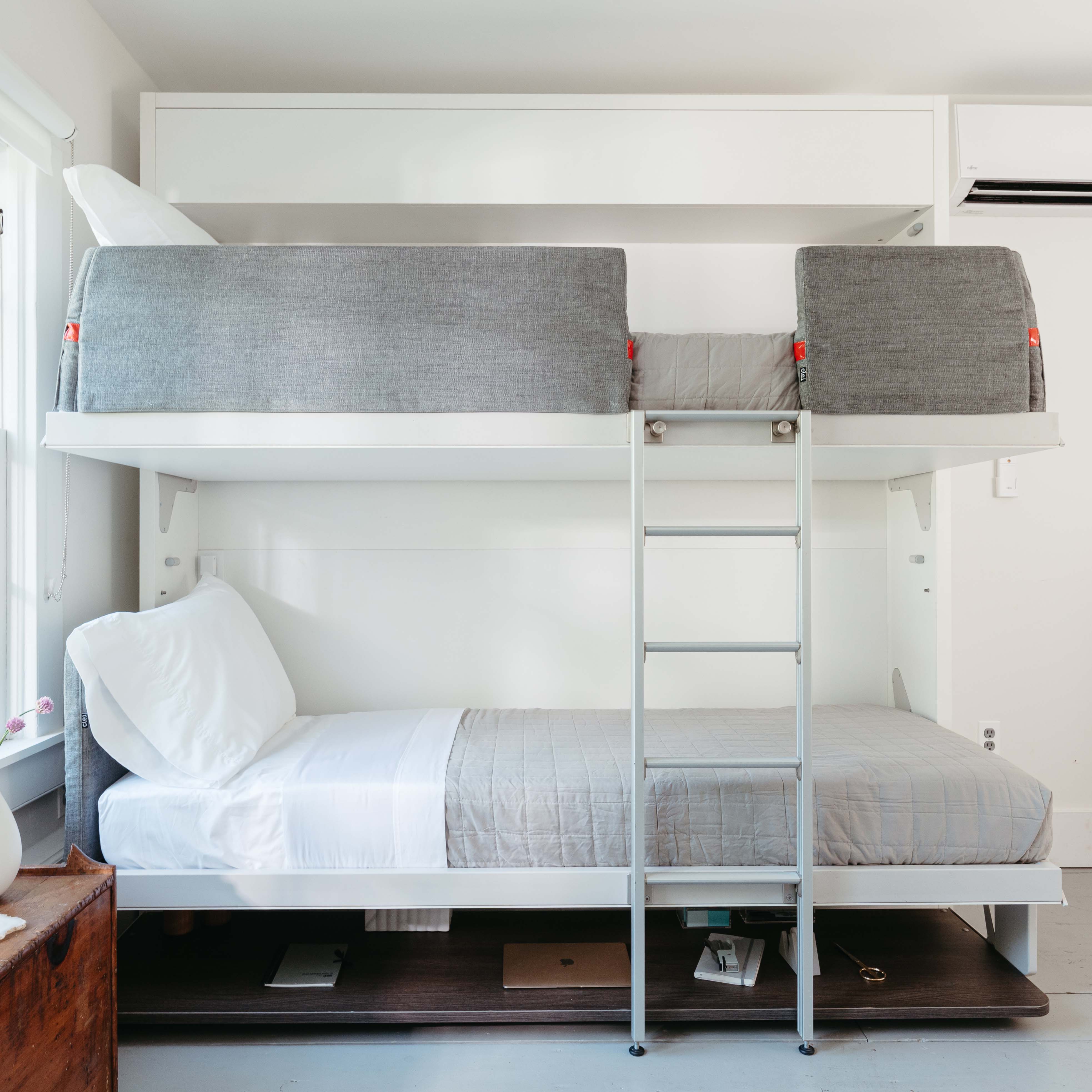 Front view of the Kali Duo Desk Murphy bunk beds fully open, showing upholstered sides and integrated ladder for upper bunk access
