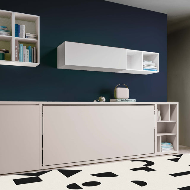 Closed Kali horizontal twin Murphy bed shown as a sleek beige cabinet with adjacent open shelving and minimalist decor.