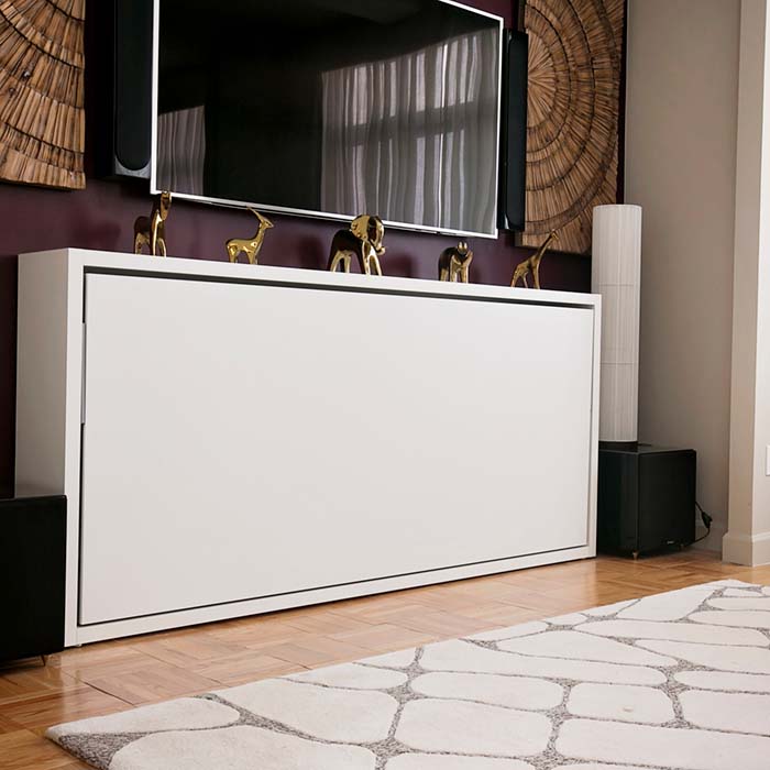 Kali horizontal twin Murphy bed in the closed position, seamlessly integrated beneath a wall-mounted TV in a modern living space.