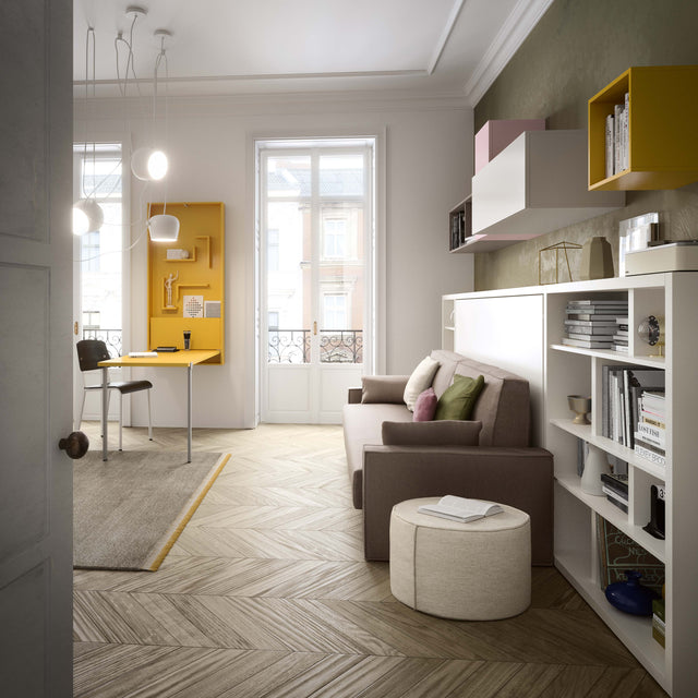 Modern living and working space featuring the Kali Sofa twin wall bed with integrated couch, surrounded by custom shelving and a fold-down yellow desk.