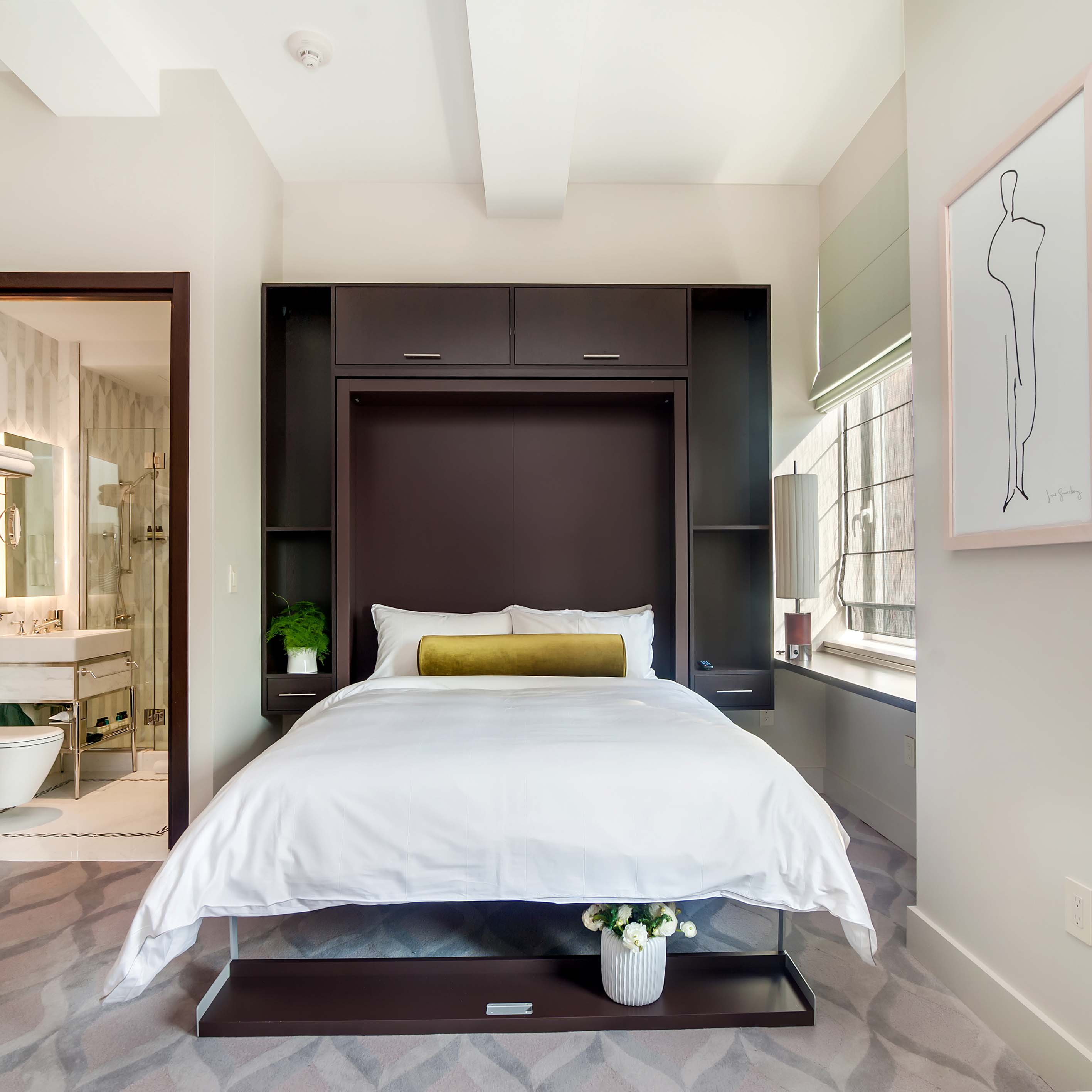 Swing 0 Murphy bed open with white bedding and dark wood cabinetry, flanked by custom storage in elegant bedroom.
