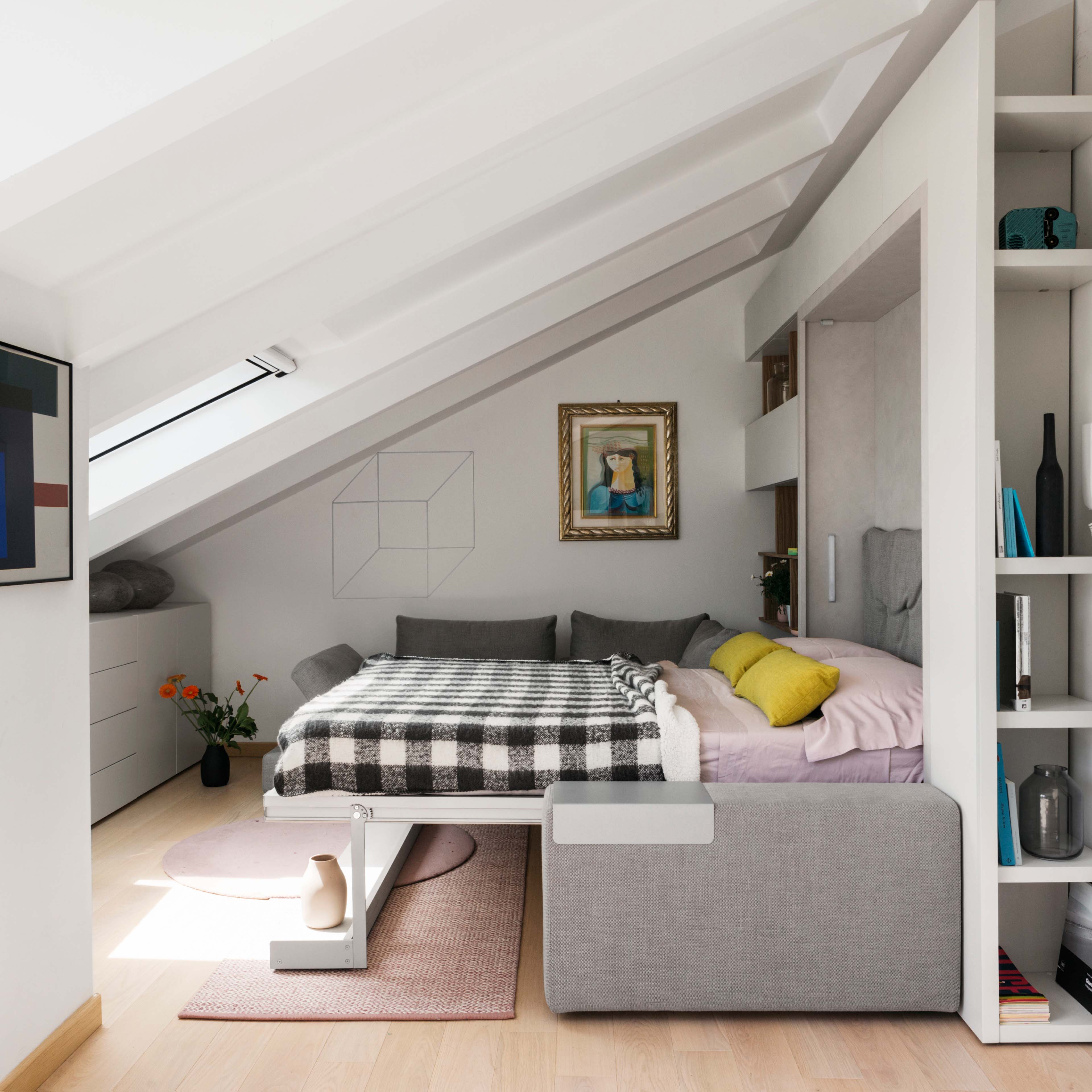 Tango Sectional wall bed system shown in bed position, with integrated couch and shelving in modern attic room.