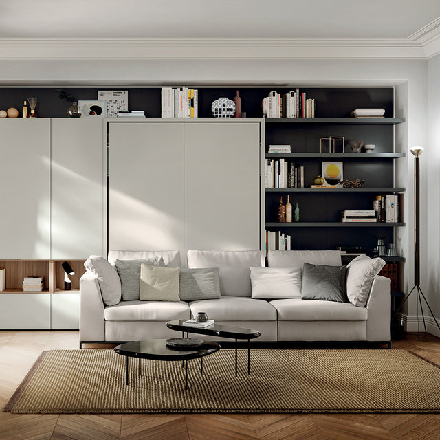 Tonale Sectional sofa in front of a closed wall bed system with integrated shelving—ideal for elegant multifunctional living spaces and modern interior design.
