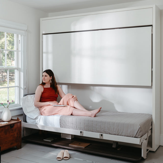 woman laying on wall bed bunk beds