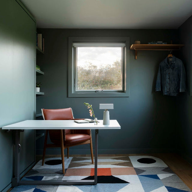 Home office with a desk and concealed Murphy bed in a Martha’s Vineyard retreat designed by Morgan Studio, photographed by Christopher Delaney.
