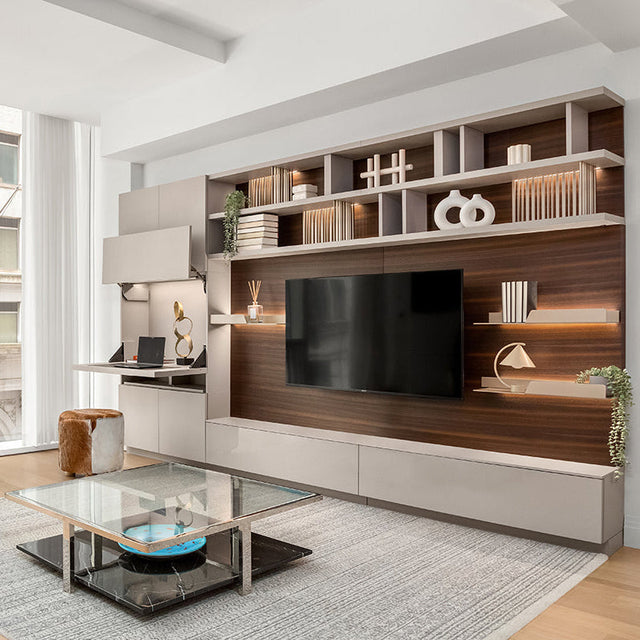 Wall-mounted shelving and flip-down desk with hidden storage in an NYC studio at One Wall Street.