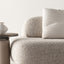 Close-up of a Bobbin side table with a neutral top, paired with a textured beige sofa and a ceramic vase, creating a minimalist and elegant look.