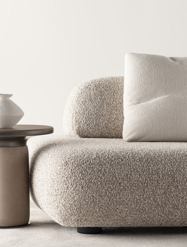 Close-up of a Bobbin side table with a neutral top, paired with a textured beige sofa and a ceramic vase, creating a minimalist and elegant look.