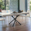 Brooklyn Mini table fully extended to its dining table form, styled for an intimate dinner with a natural outdoor view.